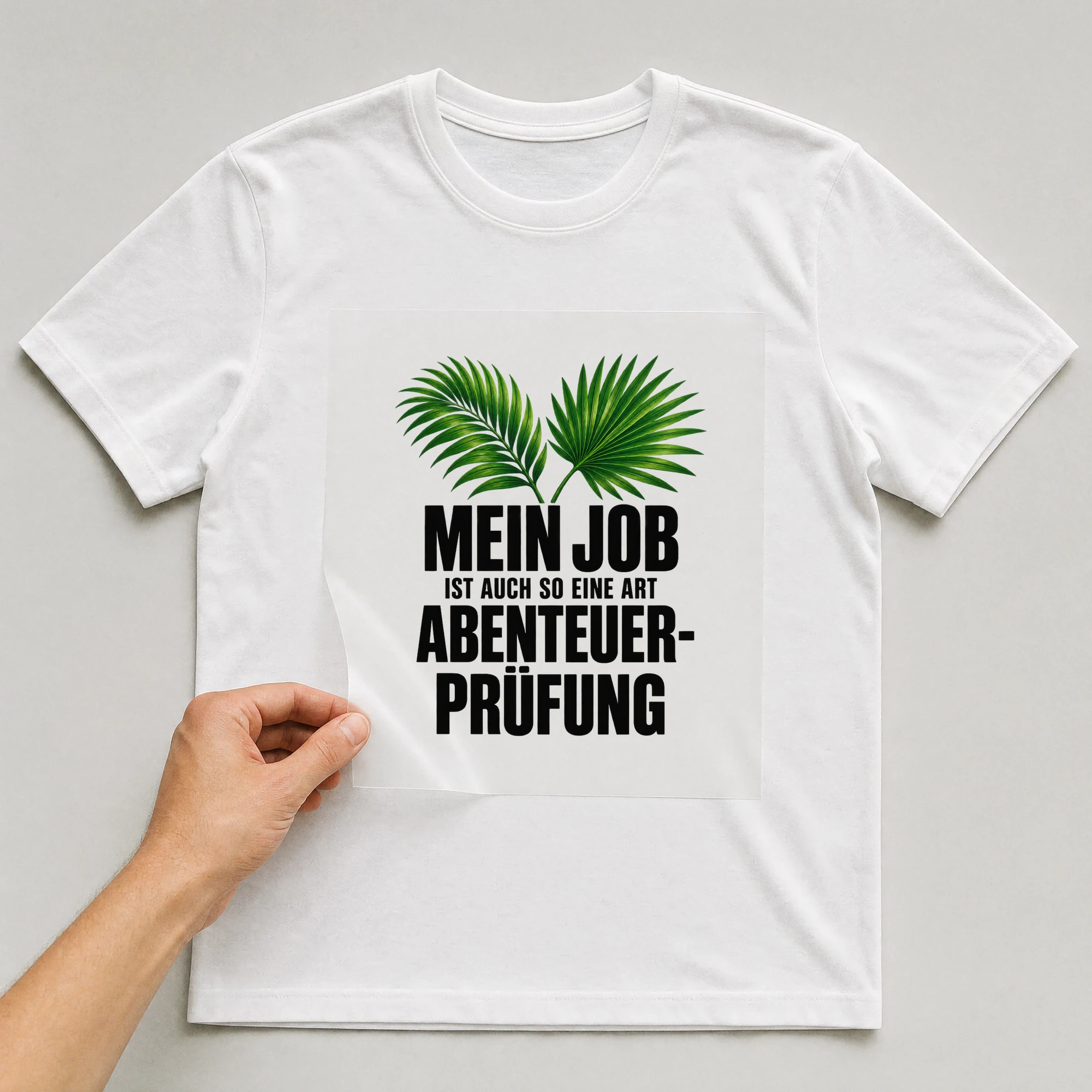 Bügelbild „Mein Job ist auch so eine Art Abenteuer-Prüfung“ auf weißem T-Shirt, Folie wird aufgelegt