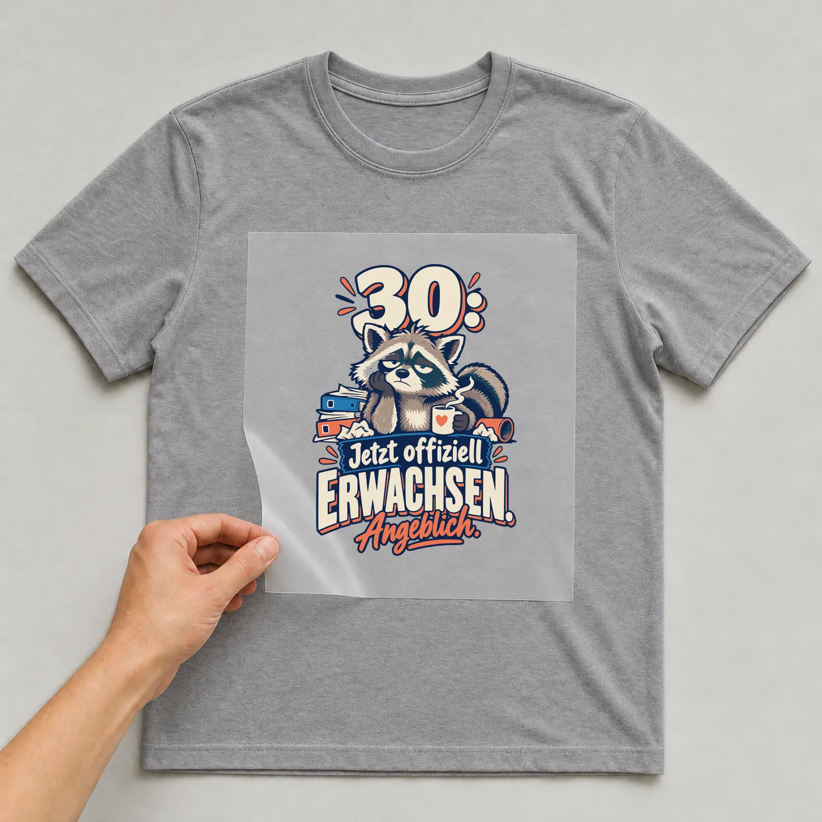Bügelbild 30: Jetzt offiziell erwachsen. Angeblich. auf grauem T-Shirt, Folie wird aufgelegt