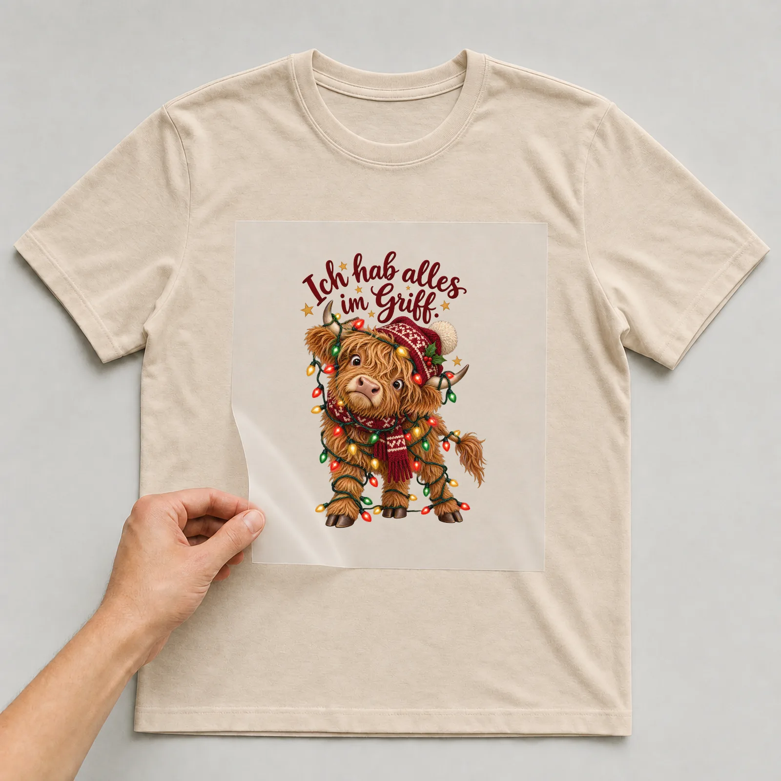 Bügelbild Ich hab alles im Griff. auf beigem T-Shirt, Folie wird aufgelegt