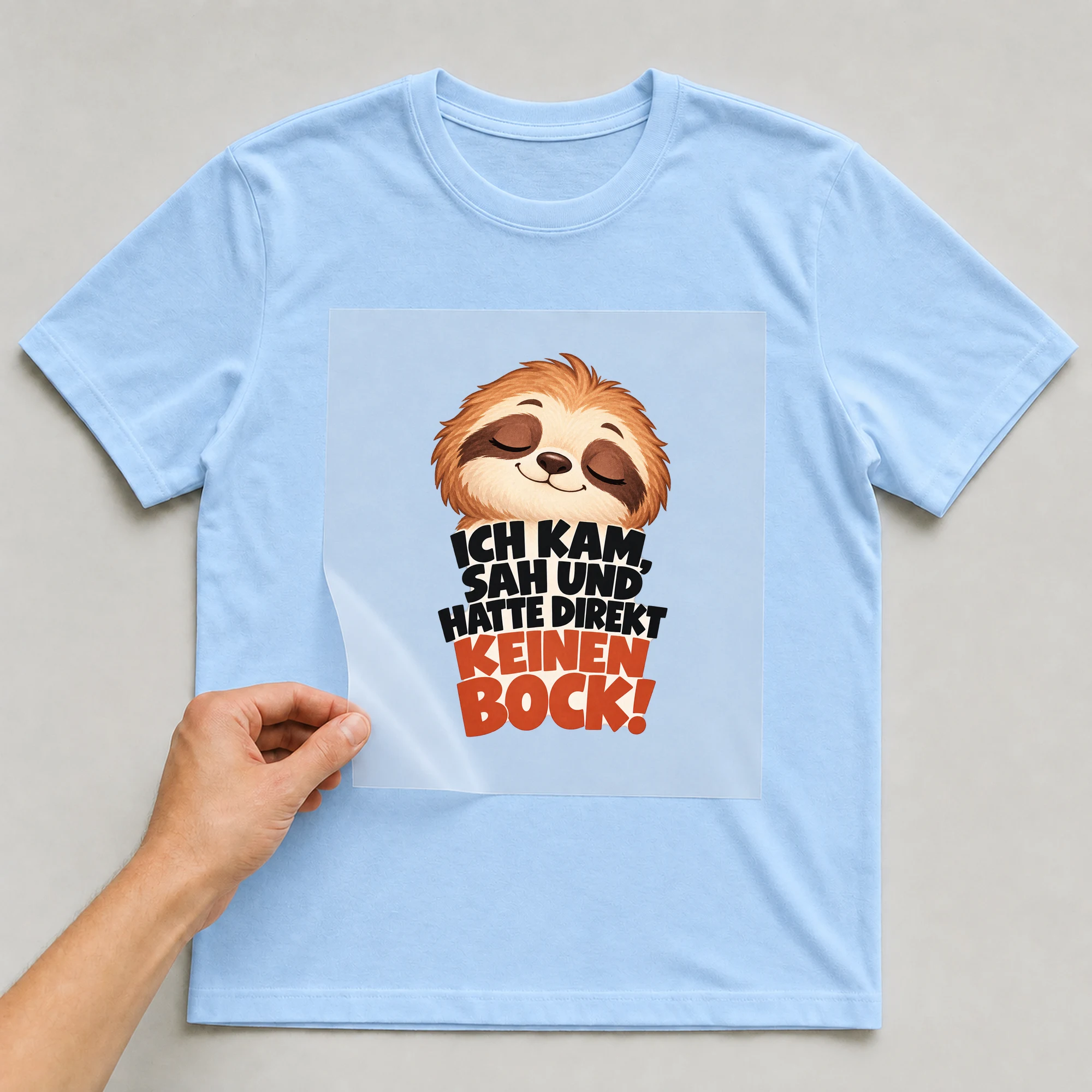 Bügelbild „Ich kam, sah und hatte direkt keinen Bock!“ auf babyblauem T-Shirt, Folie wird aufgelegt