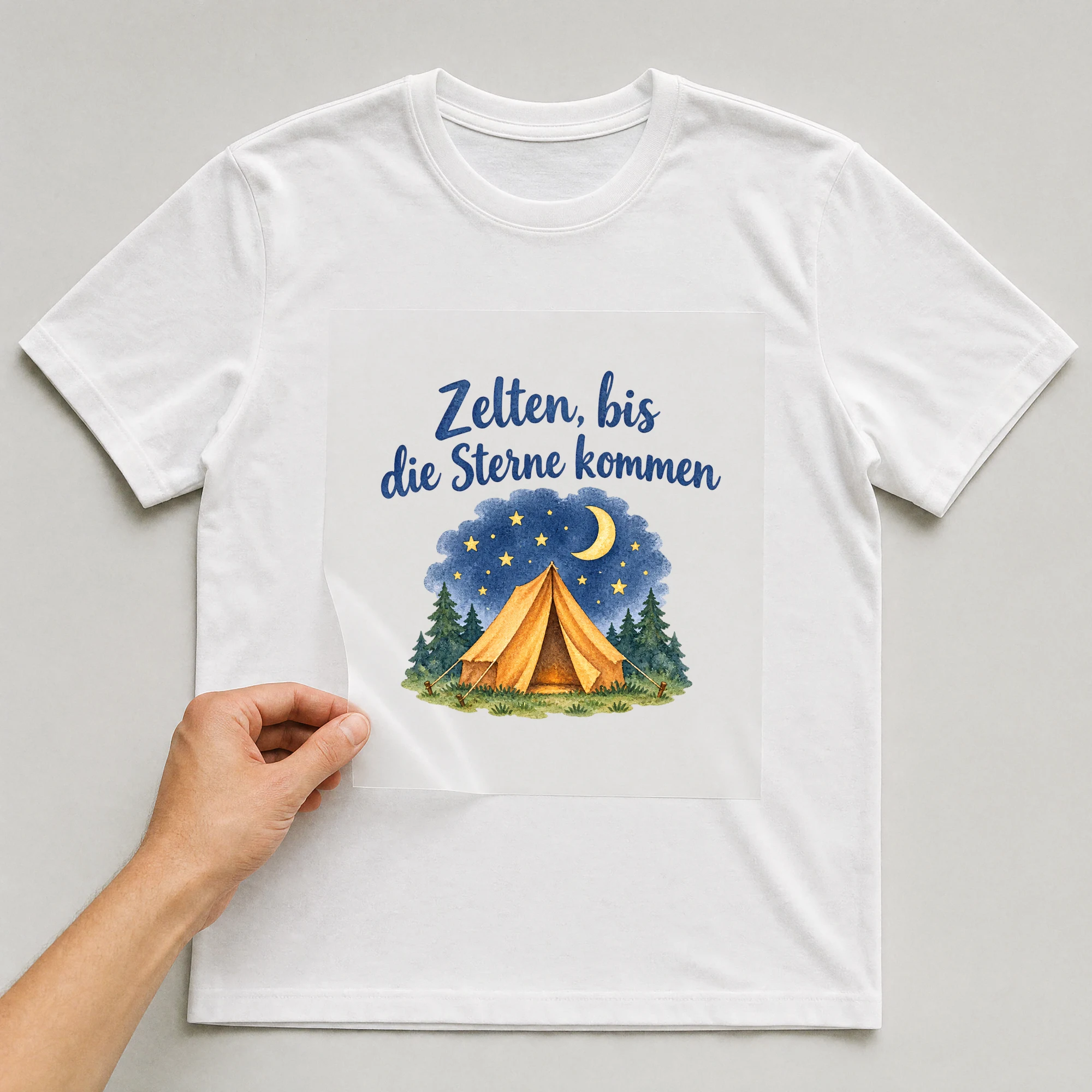 Bügelbild „Zelten, bis die Sterne kommen“ auf weißem T-Shirt, Folie wird aufgelegt