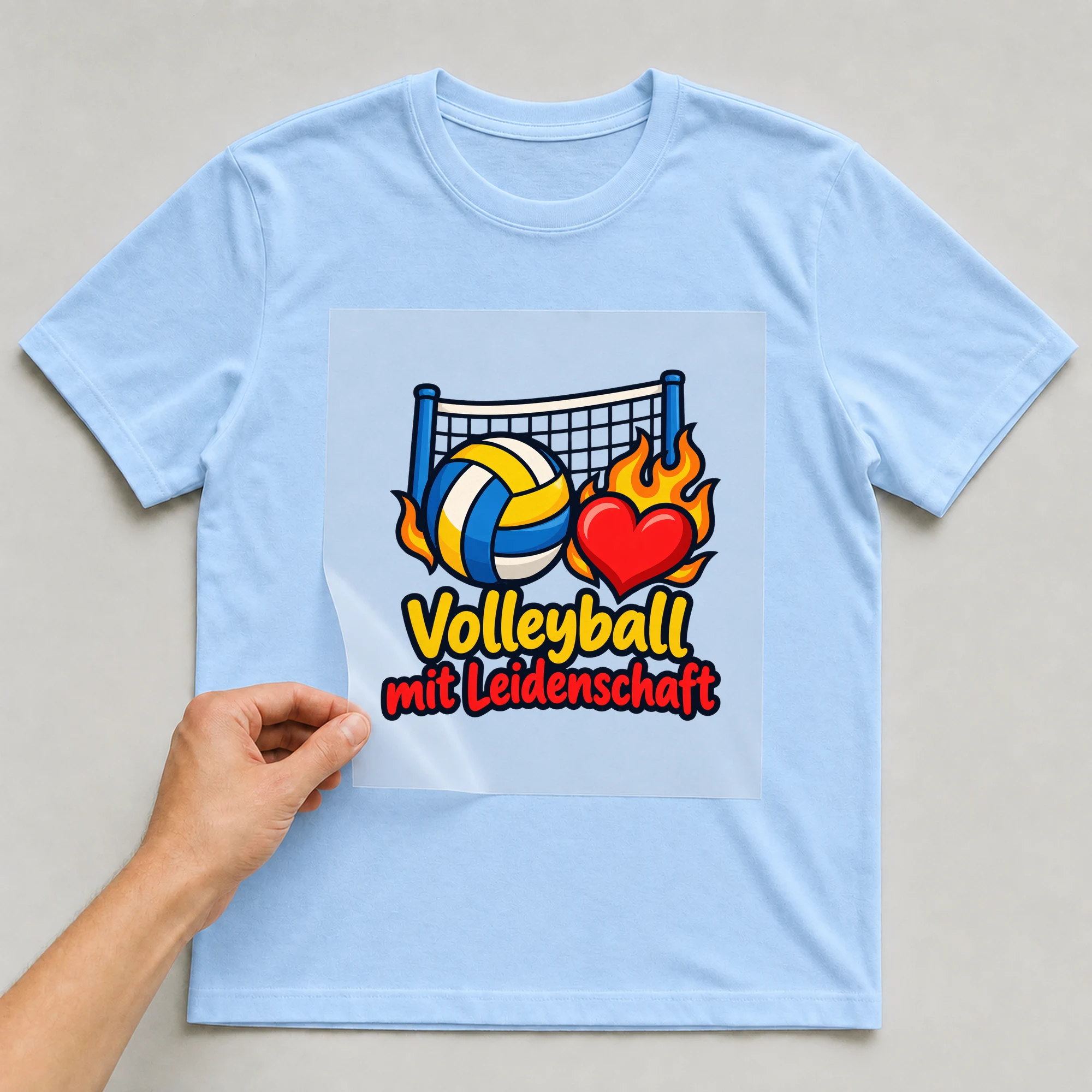 Bügelbild „Volleyball mit Leidenschaft“ auf babyblauem T-Shirt, Folie wird aufgelegt