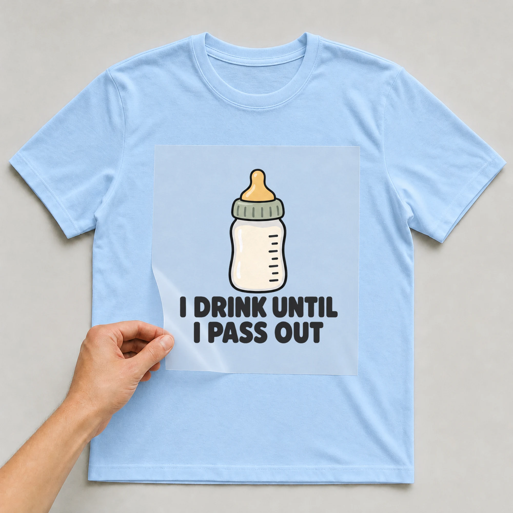 Bügelbild „I Drink Until I Pass Out“ auf babyblauem T-Shirt, Folie wird aufgelegt