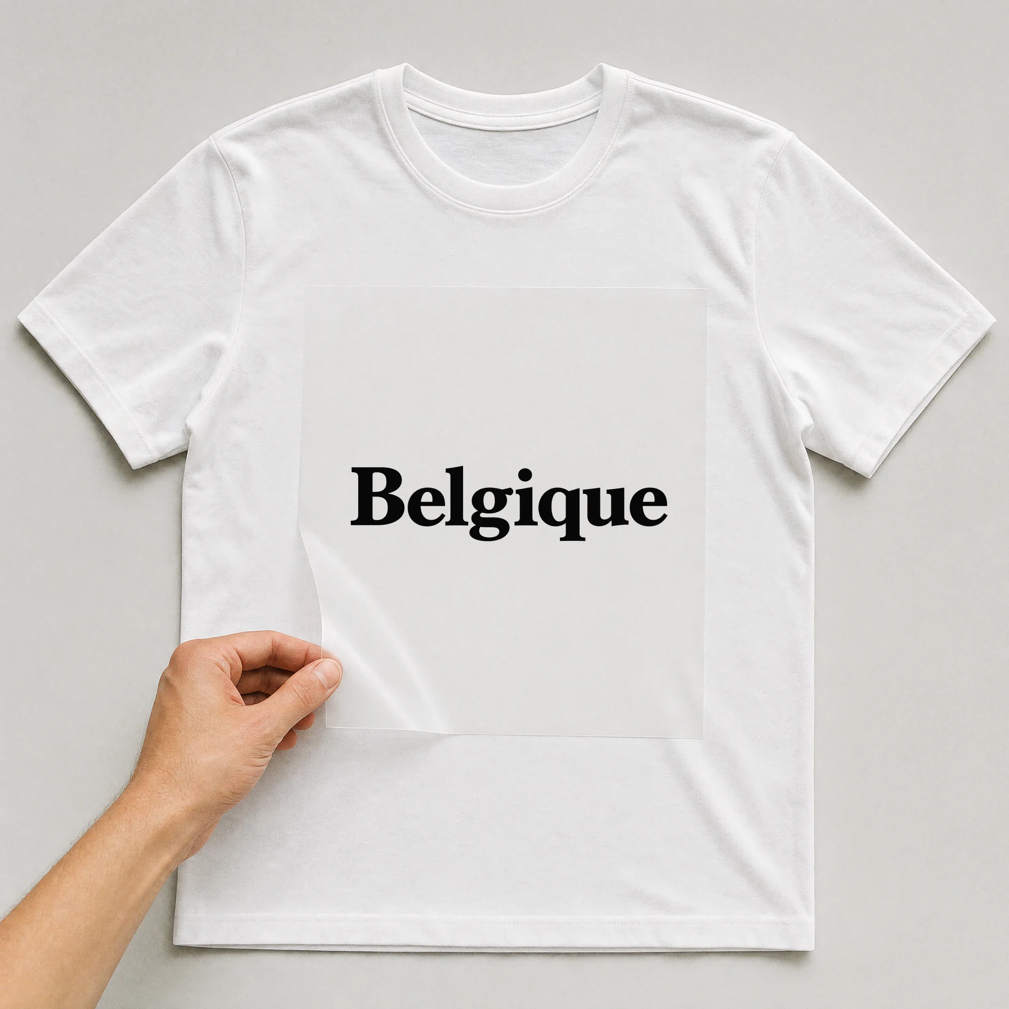 Bügelbild „Belgique“ auf weißem T-Shirt, Folie wird aufgelegt