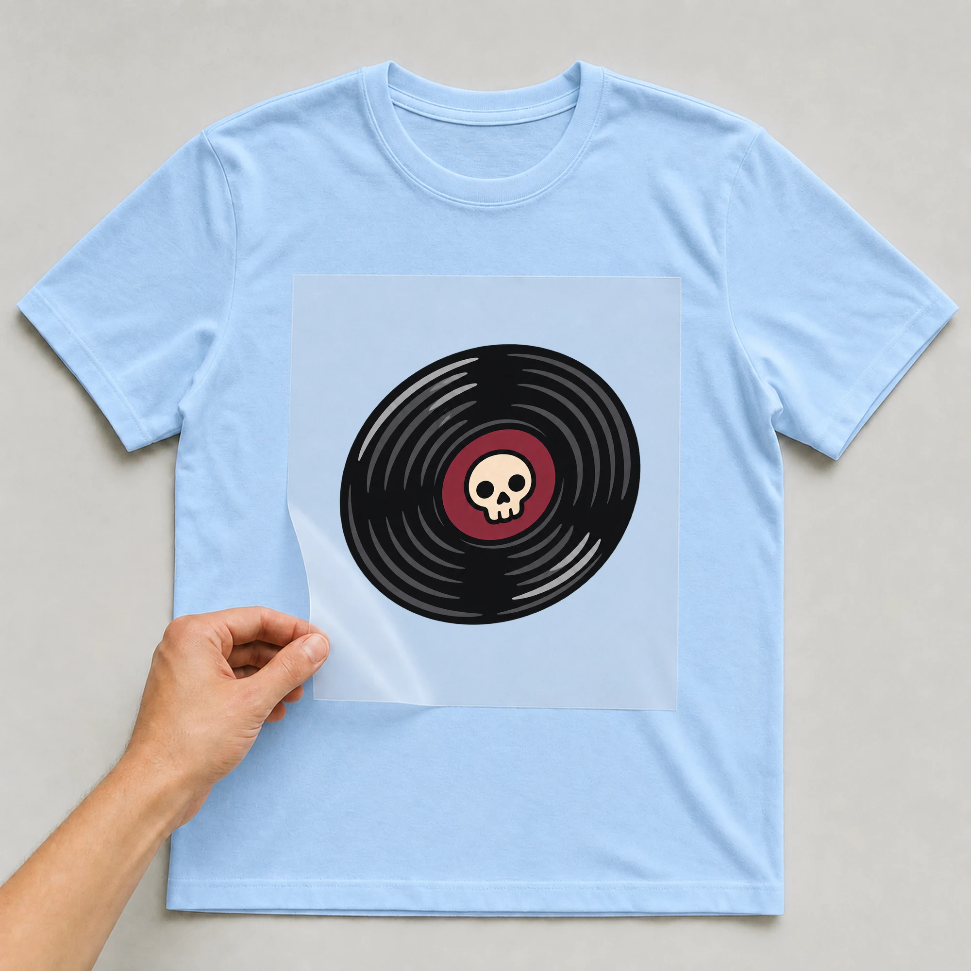 Bügelbild „BB021111-motiv-r03589“ auf babyblauem T-Shirt, Folie wird aufgelegt