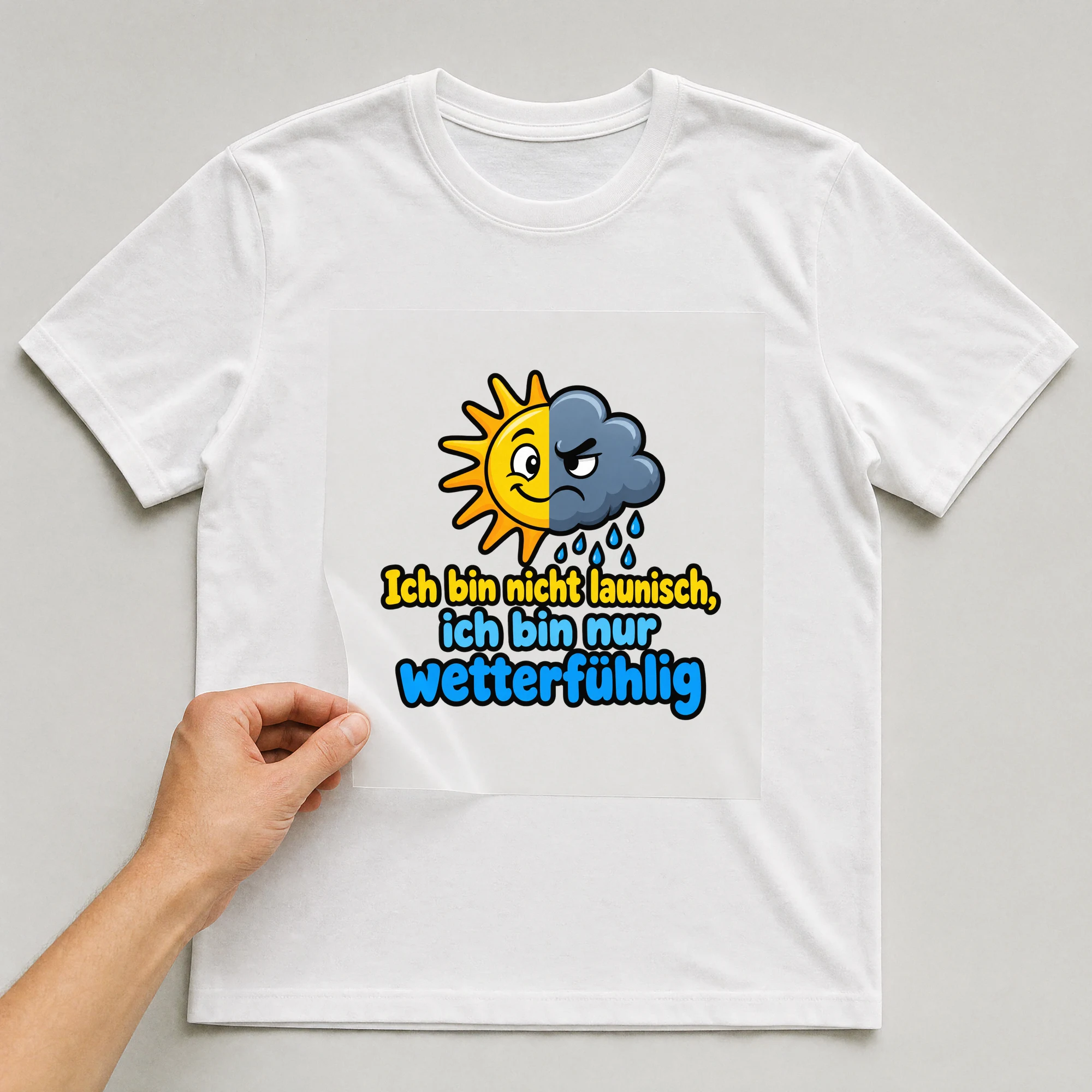 Bügelbild „Ich bin nicht launisch, ich bin nur wetterfühlig“ auf weißem T-Shirt, Folie wird aufgelegt