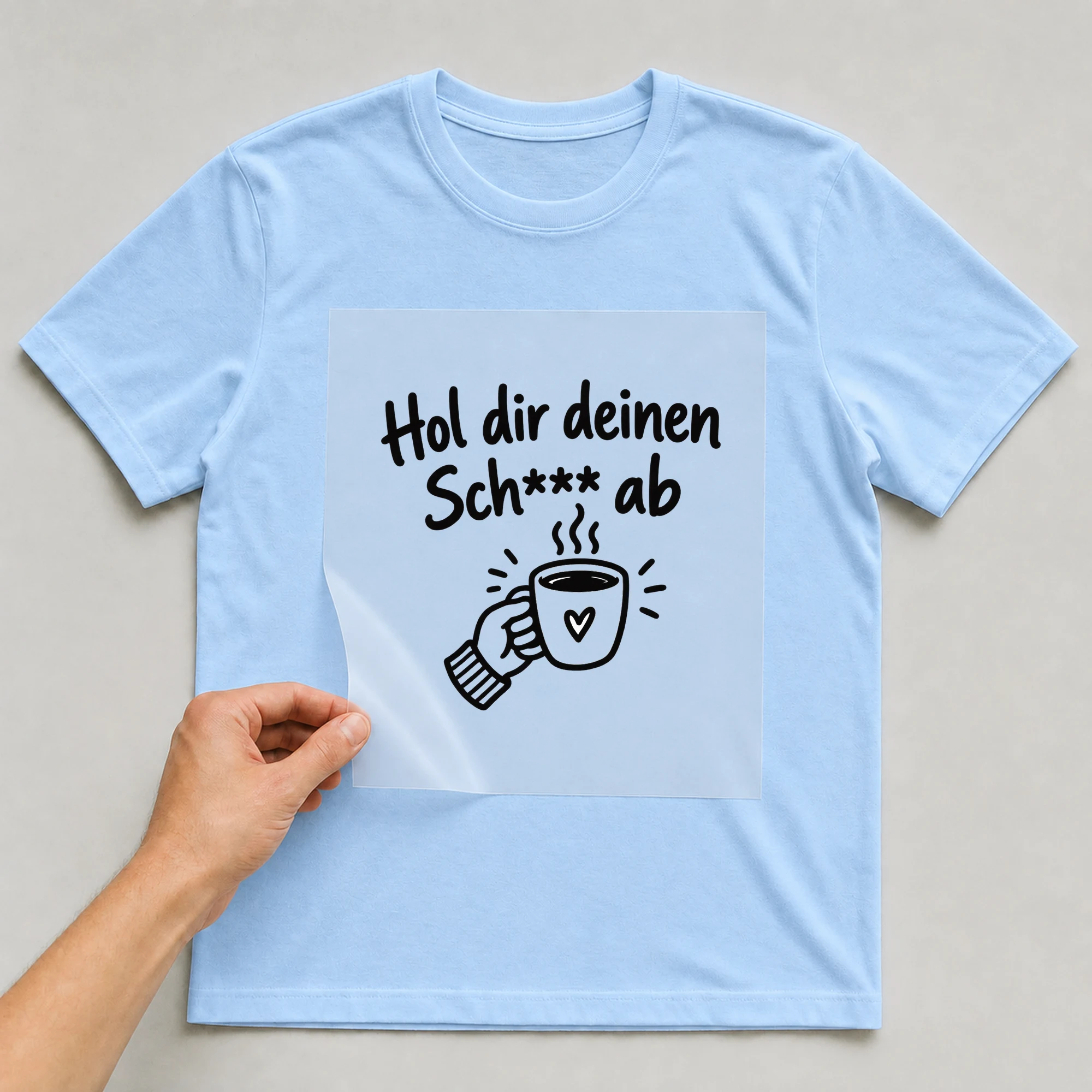 Bügelbild „Hol dir deinen Sch*** ab“ auf babyblauem T-Shirt, Folie wird aufgelegt