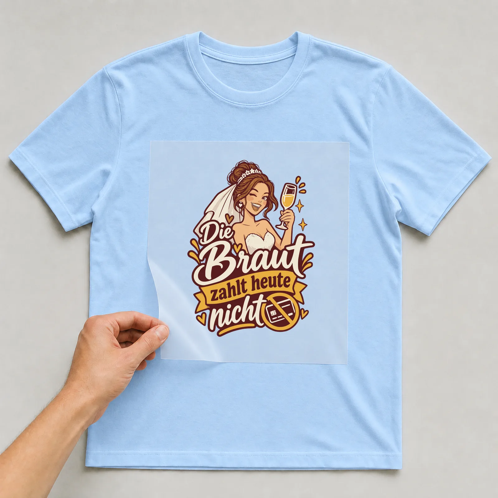 Bügelbild Die Braut zahlt heute nicht auf hellblauem T-Shirt, Folie wird aufgelegt