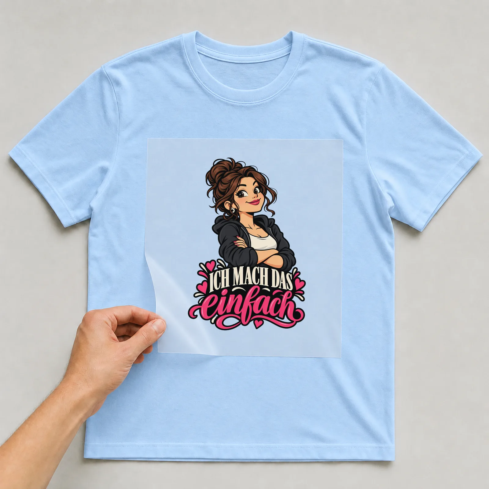 Bügelbild „Ich mach das einfach“ auf hellblauem T-Shirt, Folie wird aufgelegt