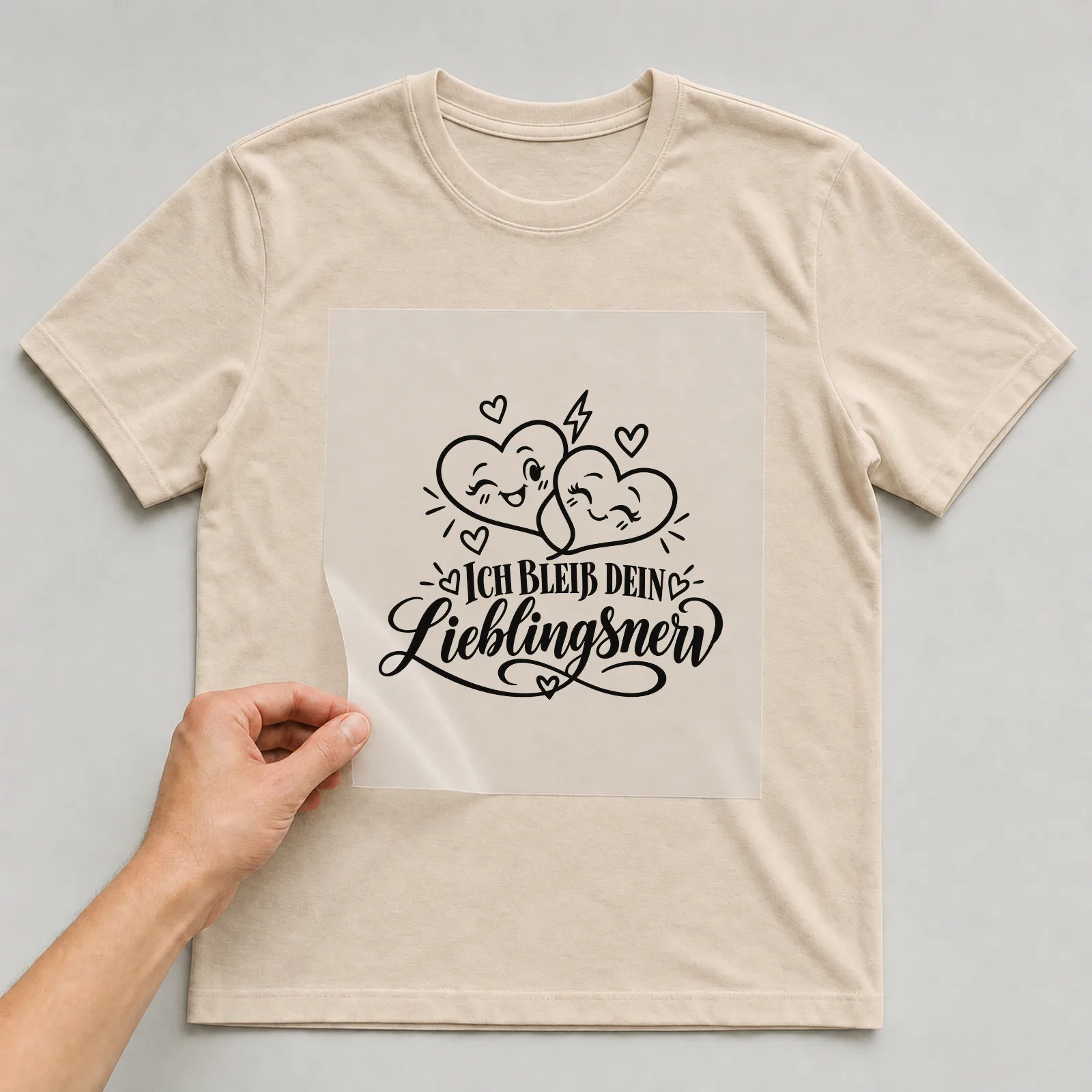 Bügelbild „Ich bleib dein Lieblingsnerv“ auf beigem T-Shirt, Folie wird aufgelegt