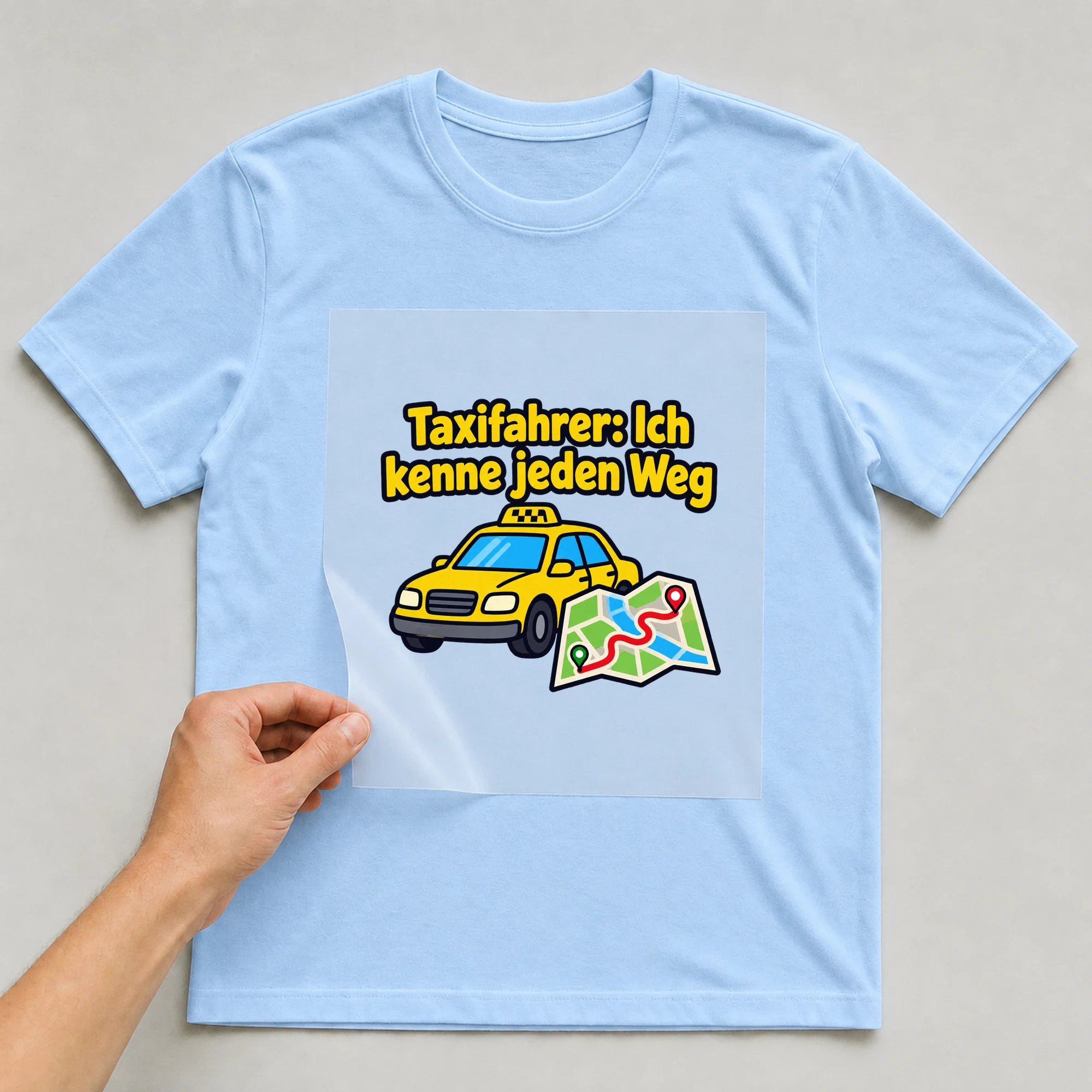 Bügelbild „Taxifahrer: Ich kenne jeden Weg“ auf babyblauem T-Shirt, Folie wird aufgelegt