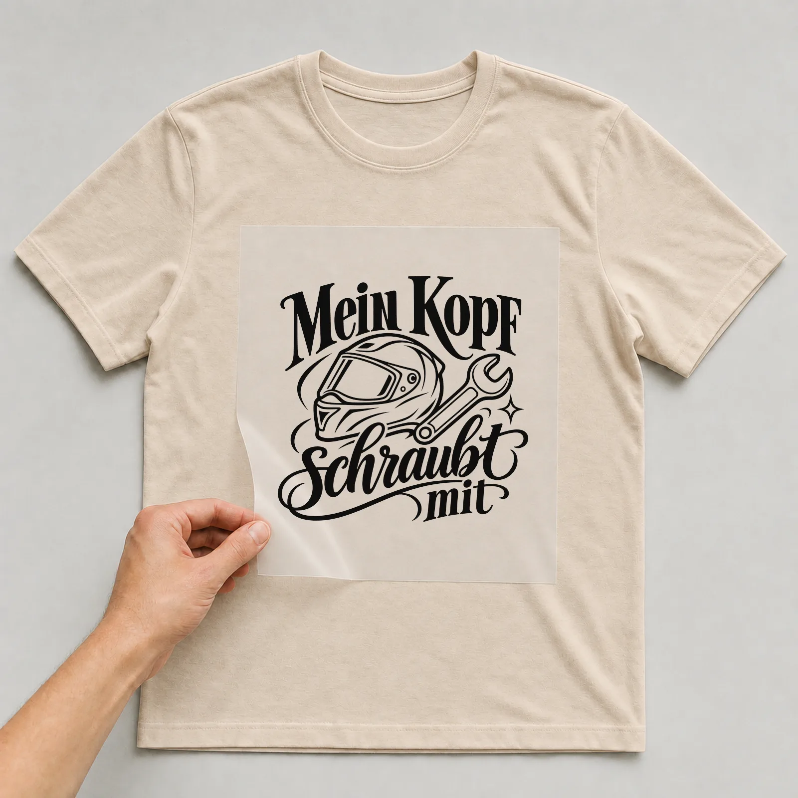 Bügelbild „Mein Kopf schraubt mit“ auf beigem T-Shirt, Folie wird aufgelegt