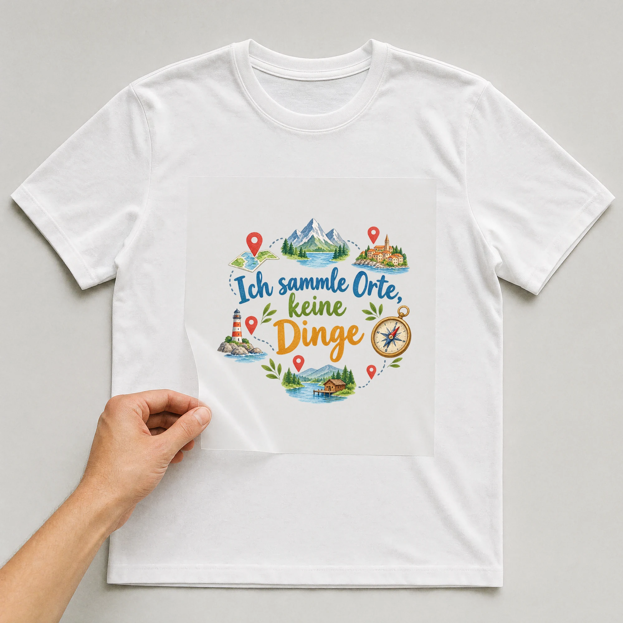 Bügelbild „Ich sammle orte keine dinge“ auf weißem T-Shirt, Folie wird aufgelegt