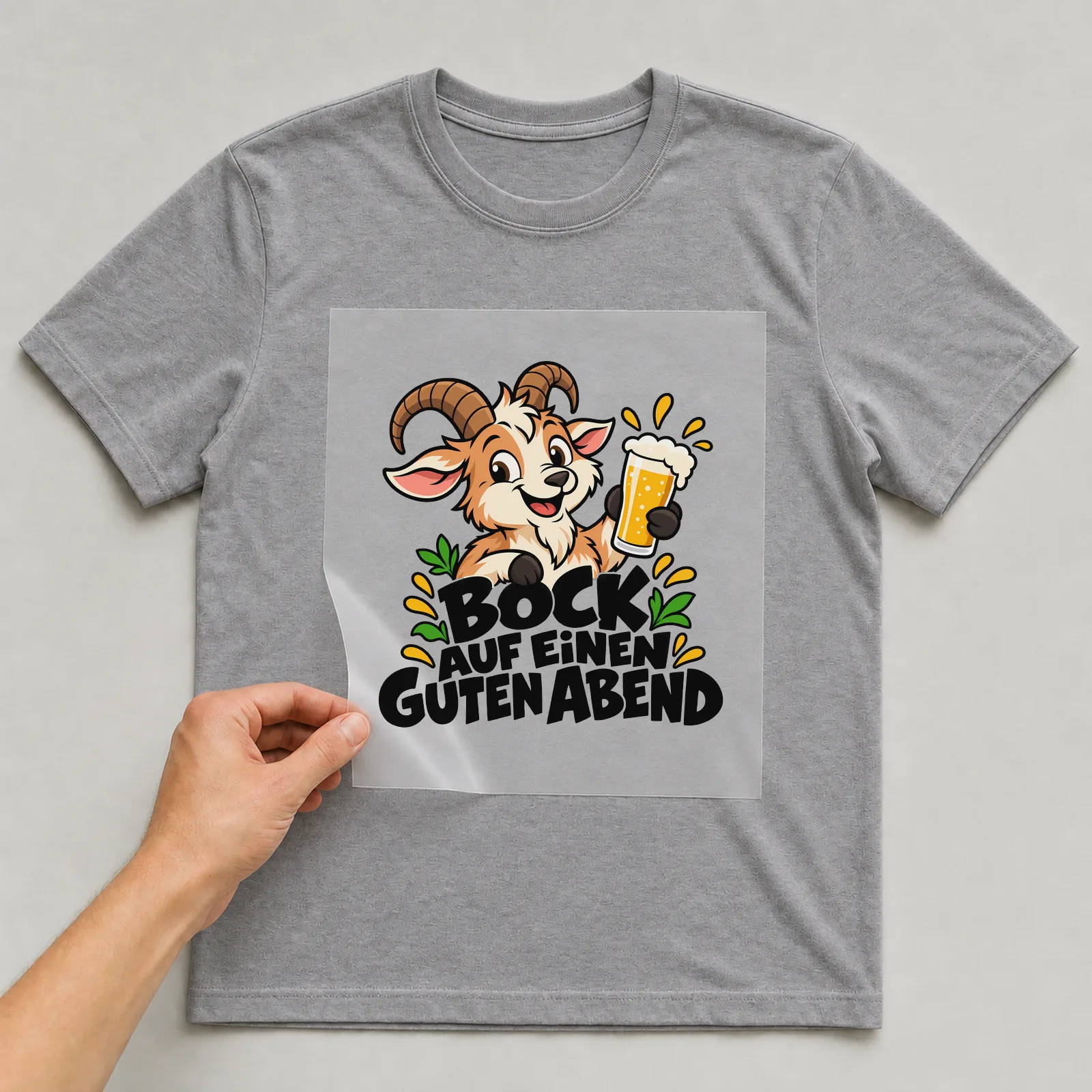 Bügelbild „Bock auf einen guten Abend“ auf grauem T-Shirt, Folie wird aufgelegt