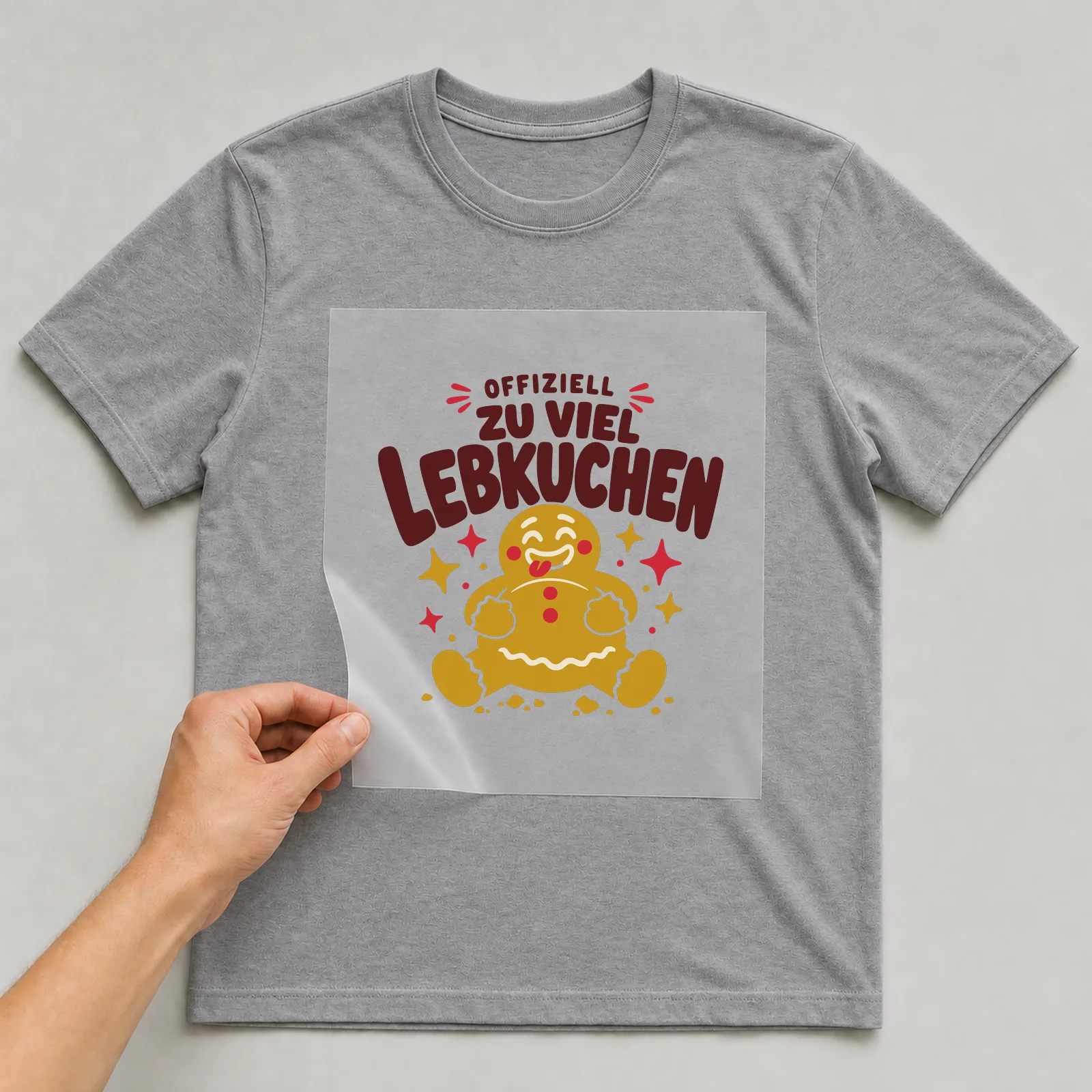 Bügelbild Offiziell zu viel Lebkuchen auf grauem T-Shirt, Folie wird aufgelegt