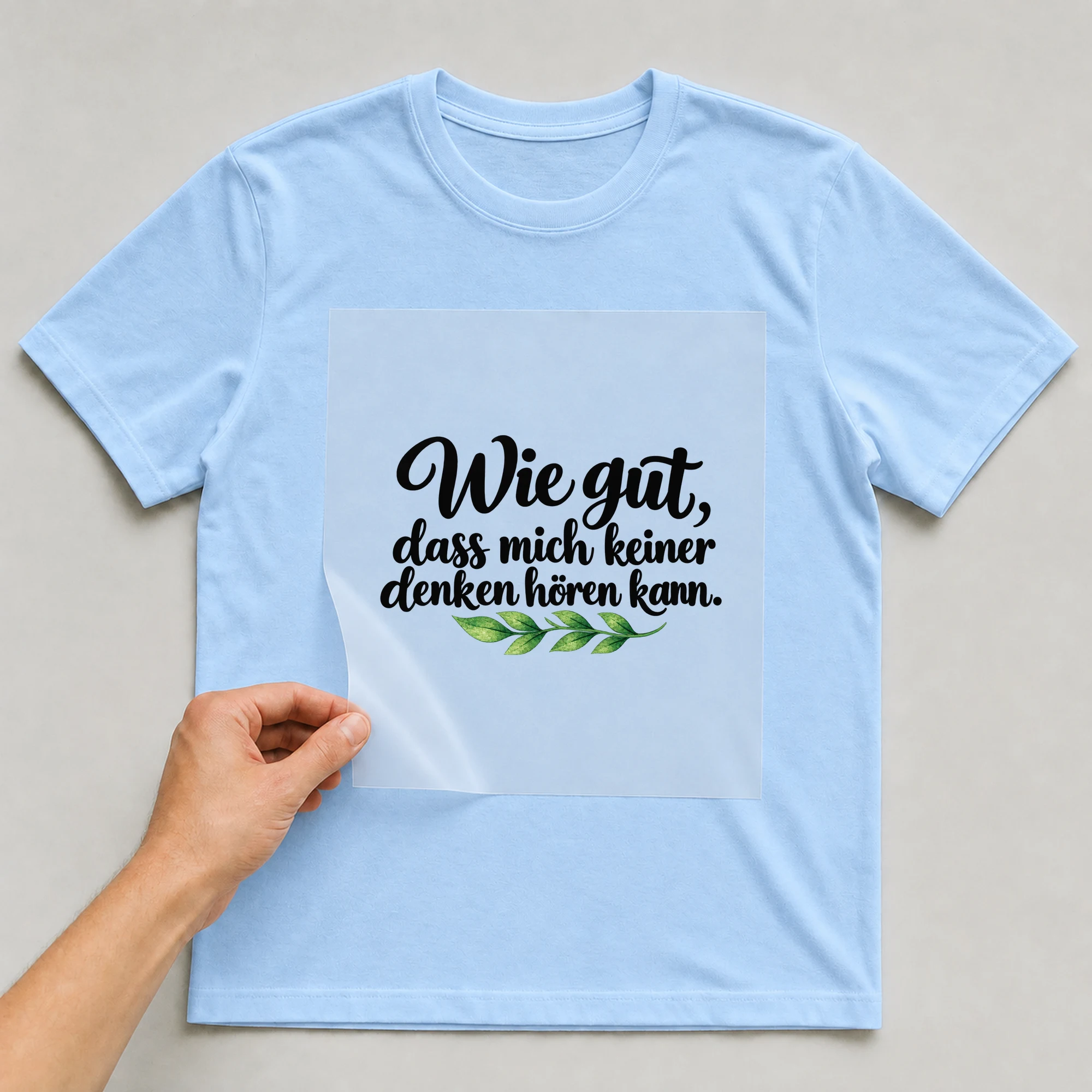 Bügelbild „Wie gut, dass mich keiner denken hören kann.“ auf babyblauem T-Shirt, Folie wird aufgelegt