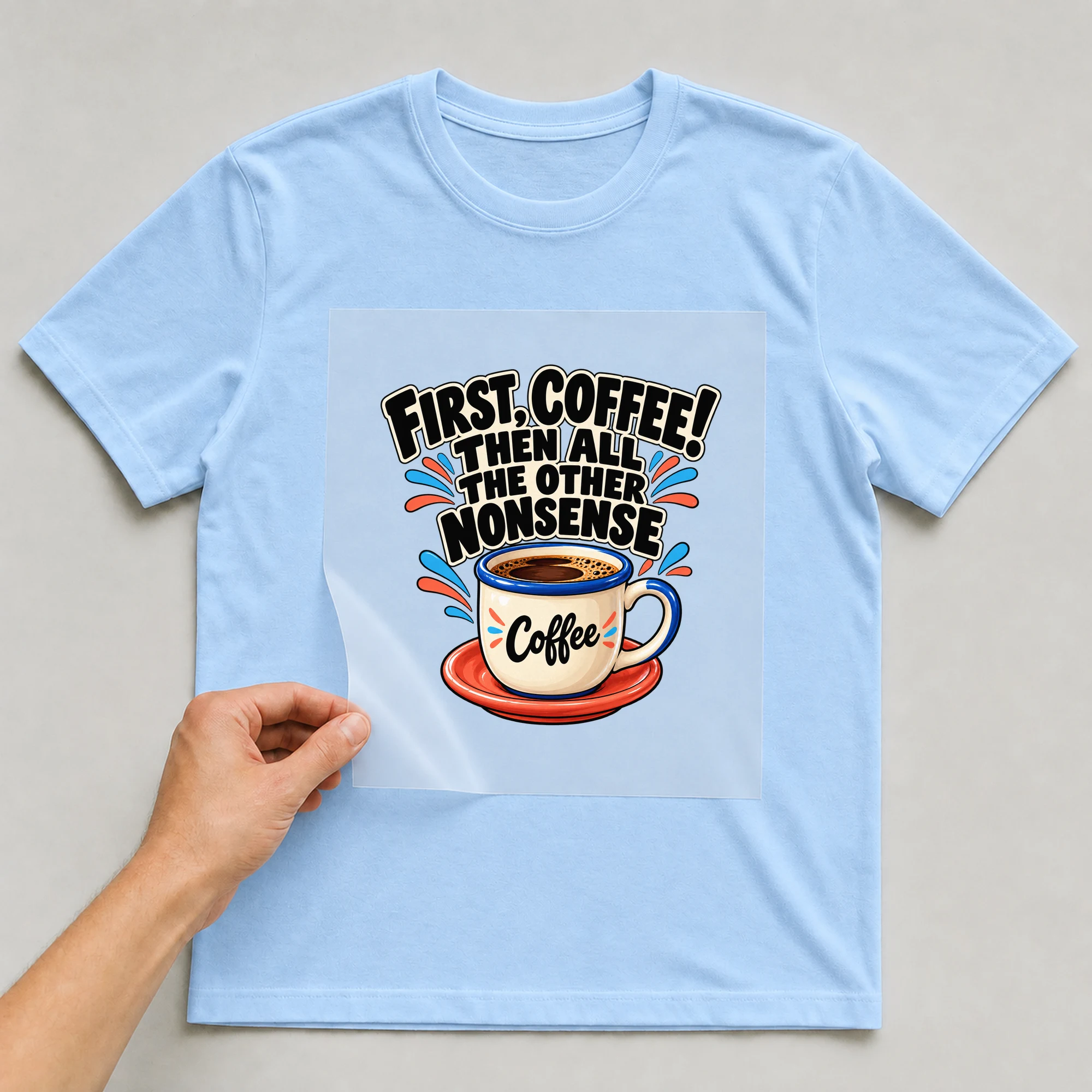 Bügelbild „First, Coffee! Then All The Other Nonsense Coffee“ auf babyblauem T-Shirt, Folie wird aufgelegt