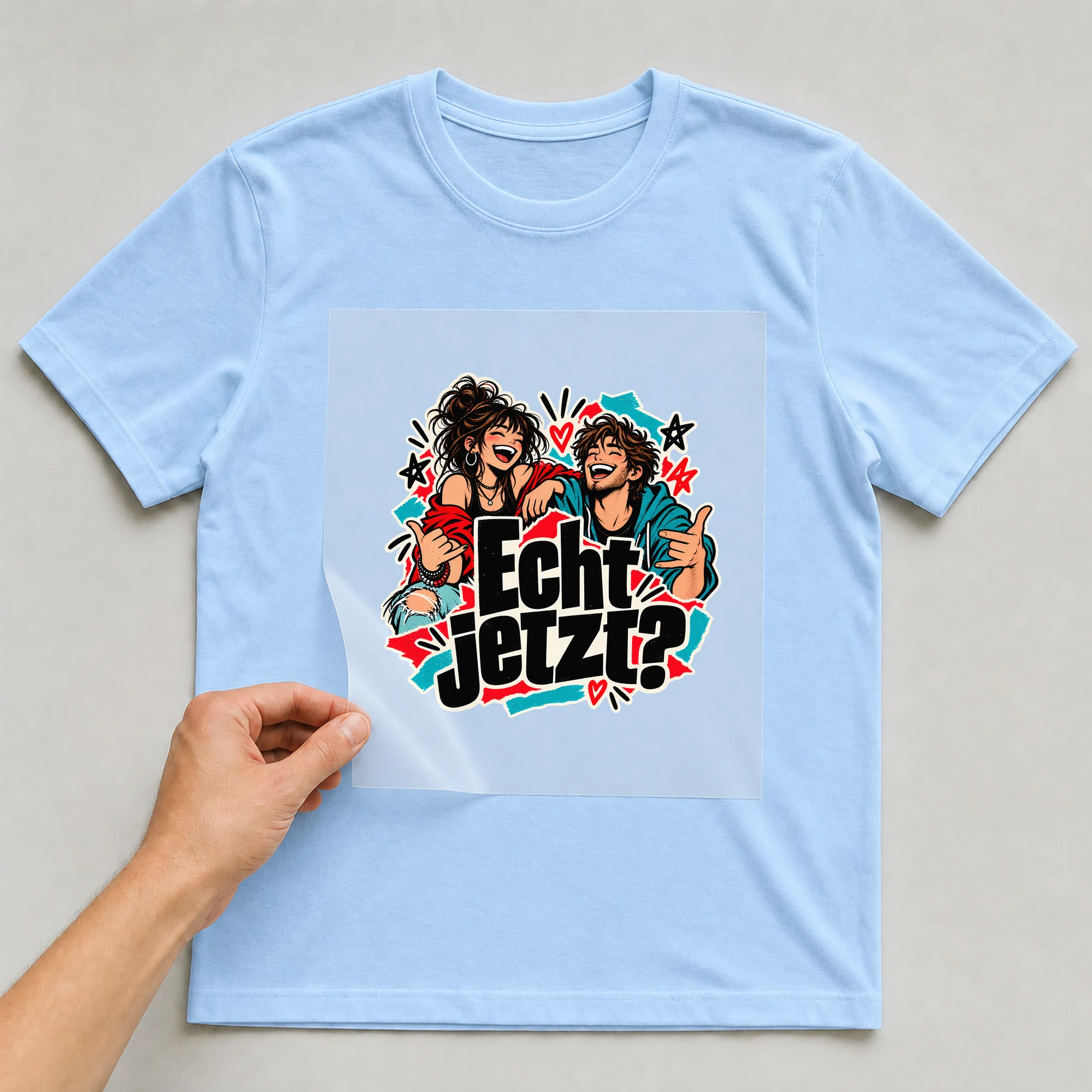 Bügelbild „Echt jetzt?“ auf babyblauem T-Shirt, Folie wird aufgelegt