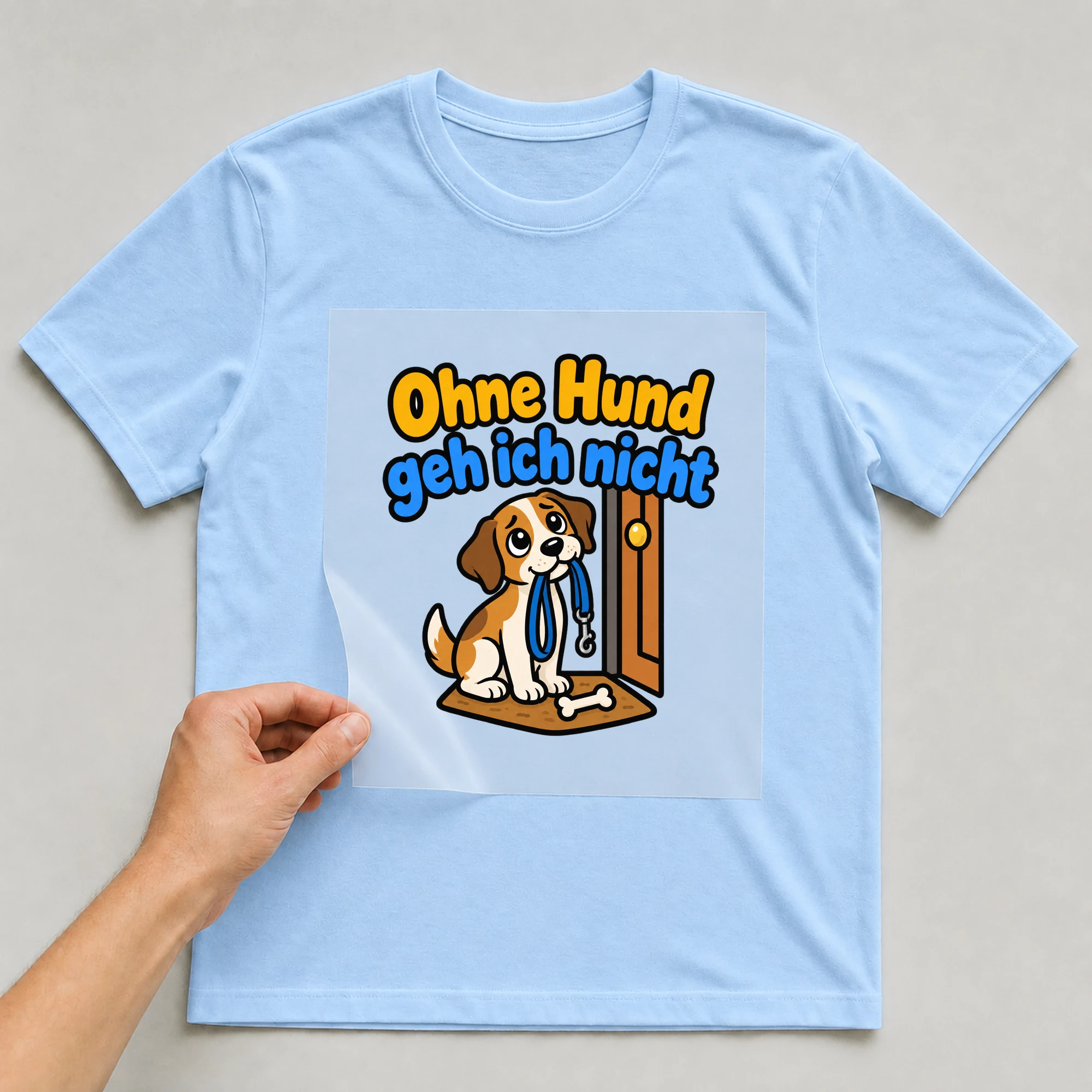 Bügelbild „Ohne Hund geh ich nicht“ auf babyblauem T-Shirt, Folie wird aufgelegt