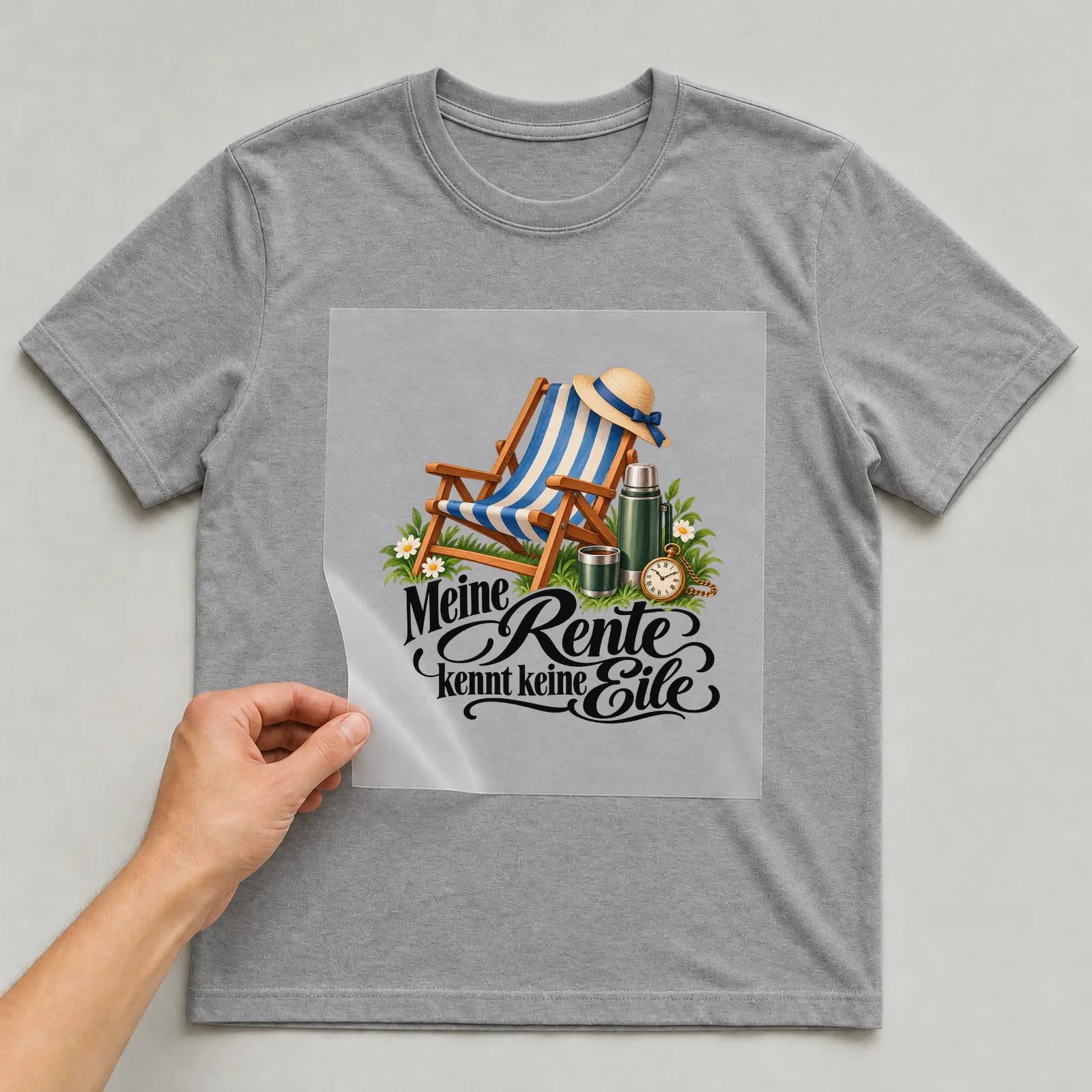 Bügelbild „Meine Rente kennt keine Eile“ auf grauem T-Shirt, Folie wird aufgelegt
