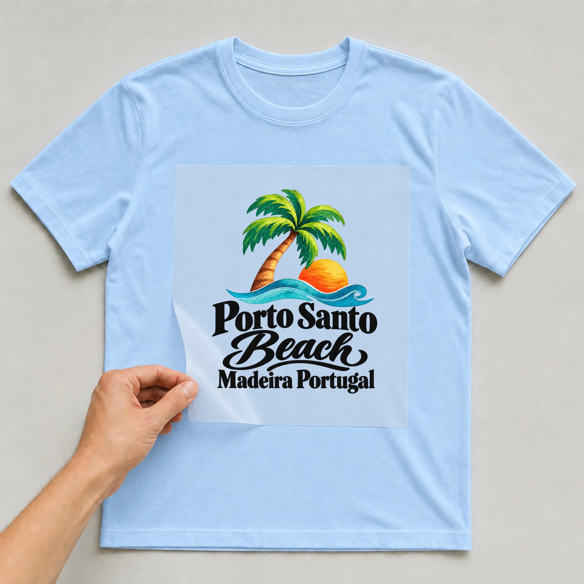 Bügelbild „Porto Santo Beach Madeira Portugal“ auf babyblauem T-Shirt, Folie wird aufgelegt
