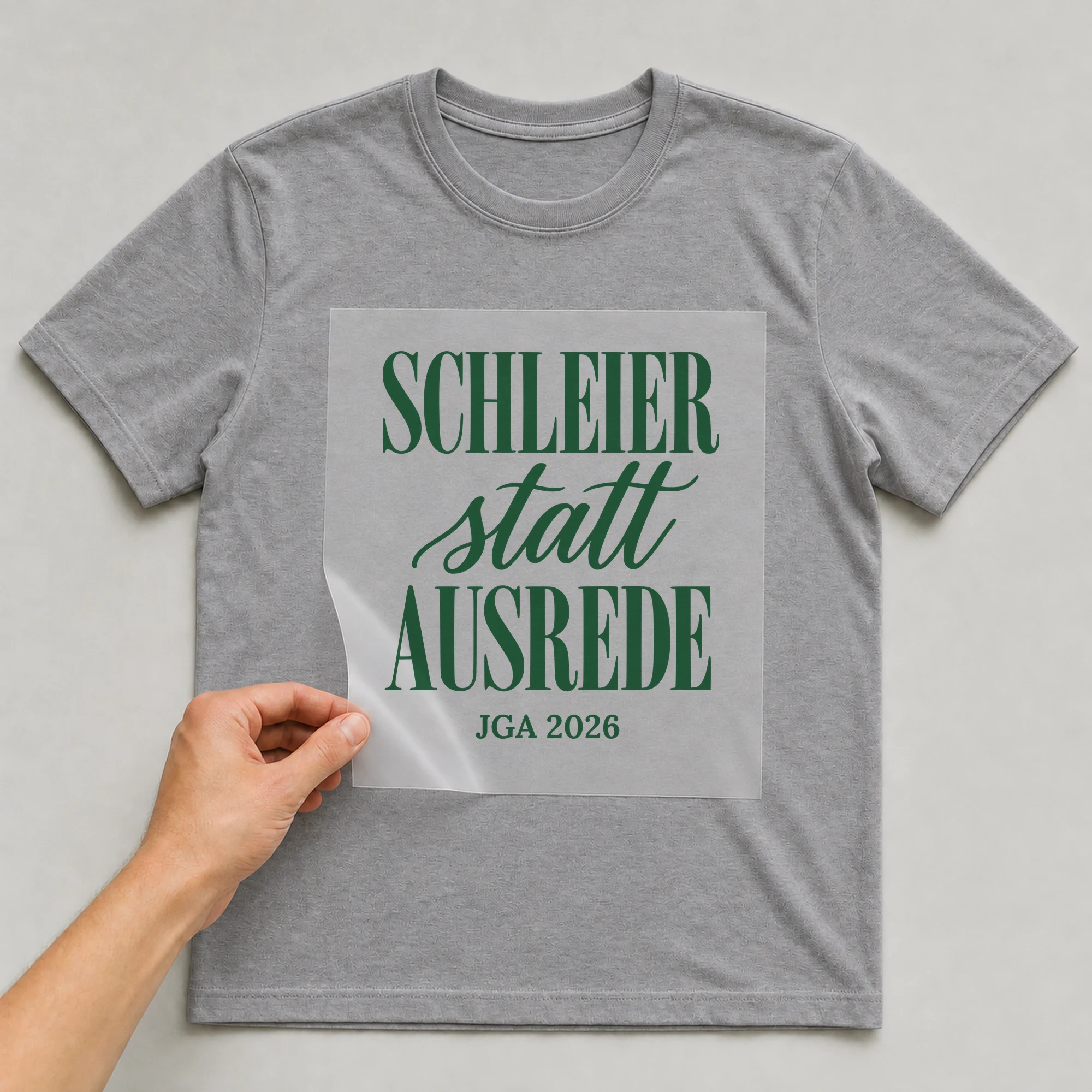 Bügelbild Schleier statt Ausrede auf grauem T-Shirt, Folie wird aufgelegt