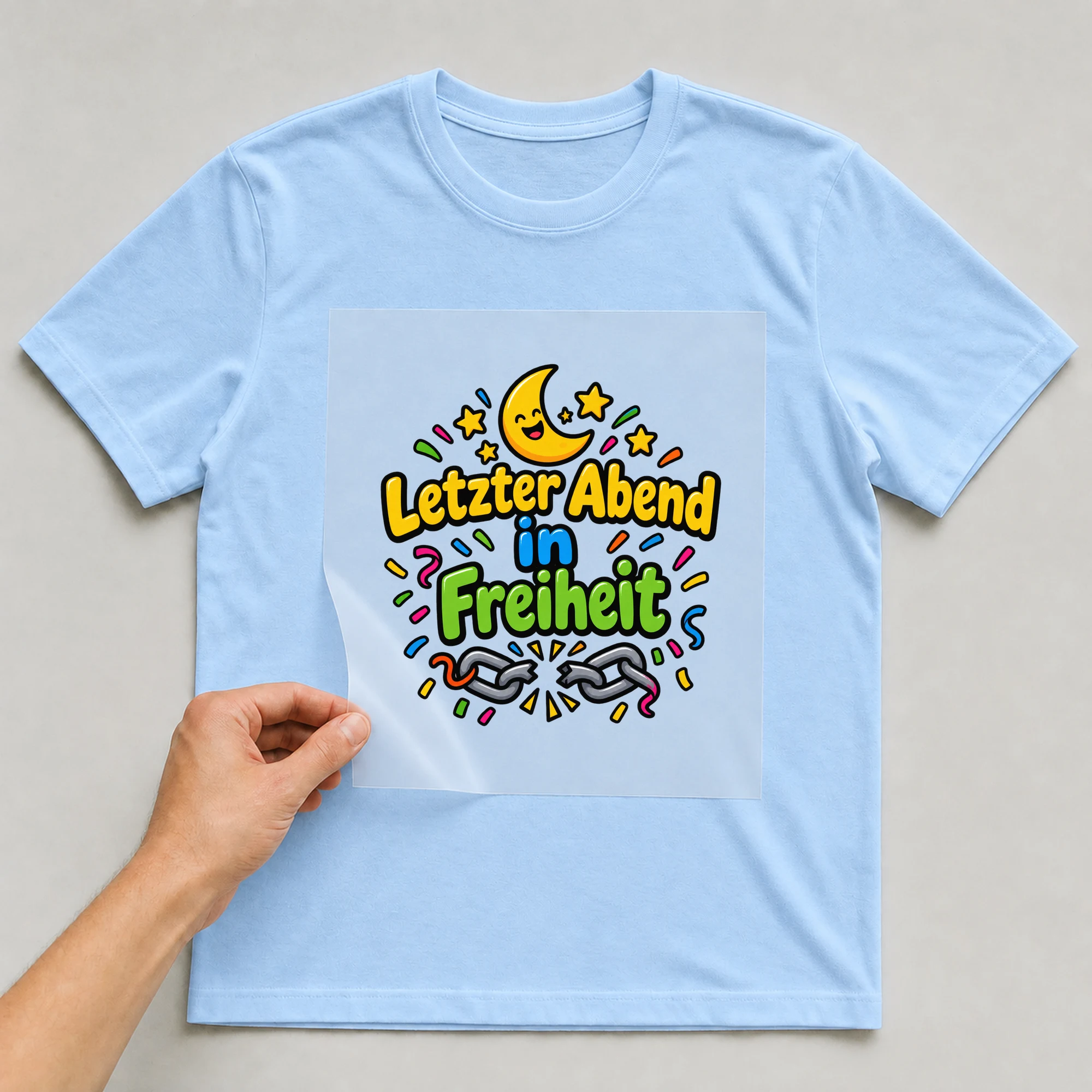 Bügelbild „Letzter abend in freiheit“ auf babyblauem T-Shirt, Folie wird aufgelegt