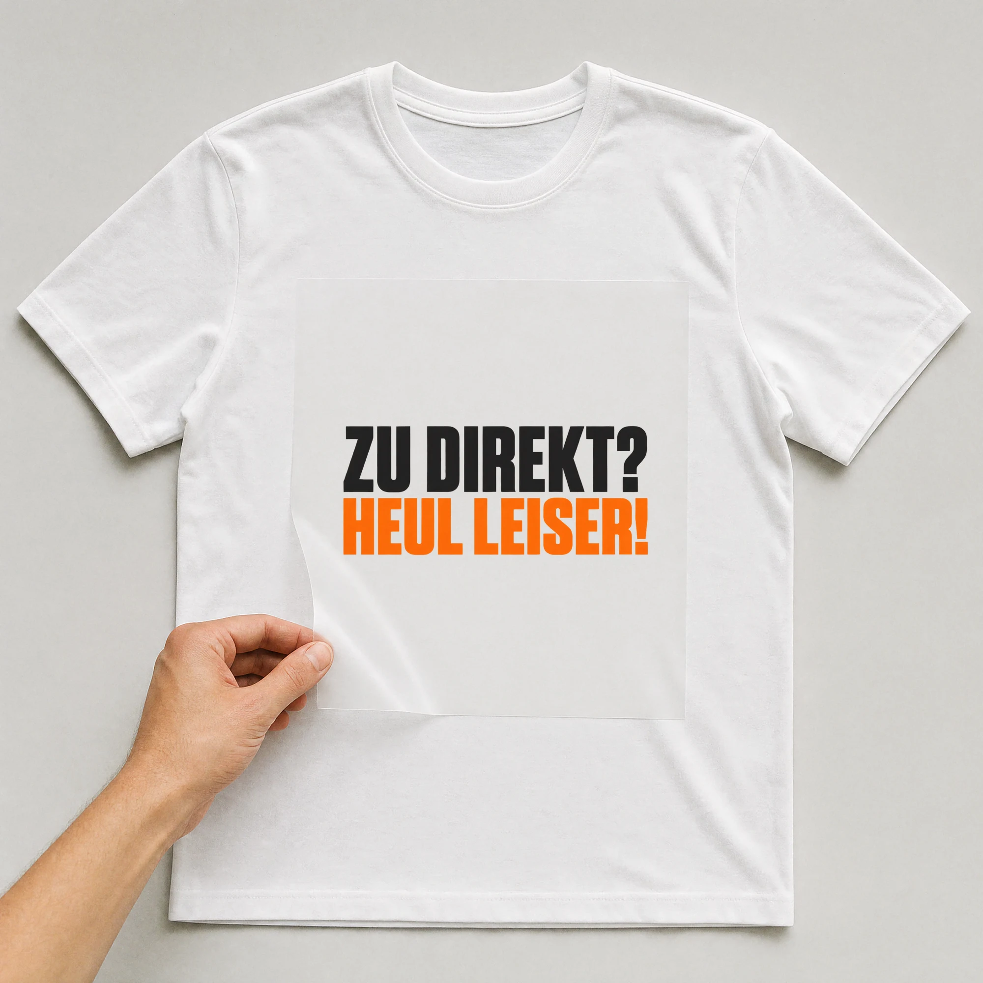Bügelbild „Zu direkt? Heul leiser!“ auf weißem T-Shirt, Folie wird aufgelegt