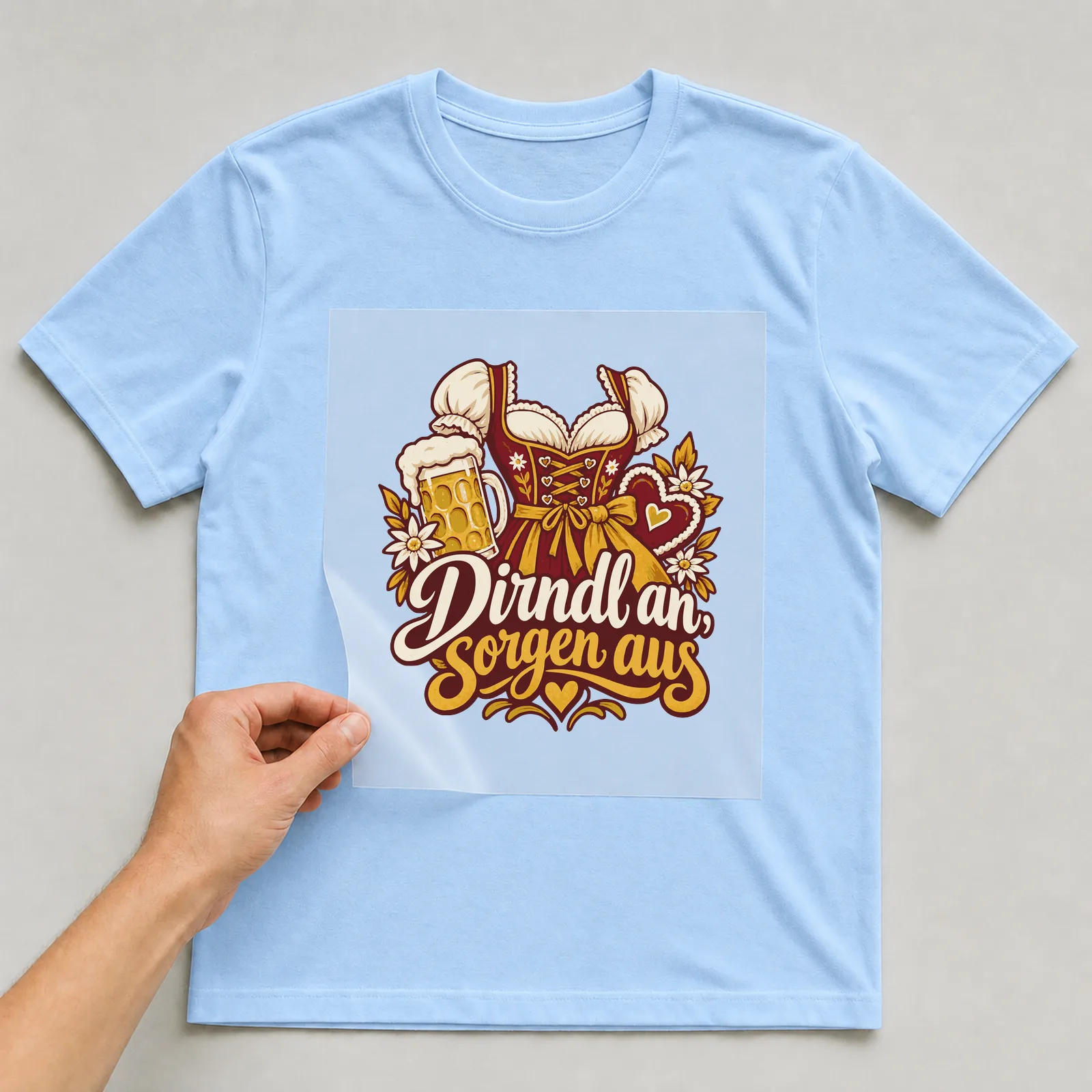 Bügelbild Dirndl an, Sorgen aus auf hellblauem T-Shirt, Folie wird aufgelegt