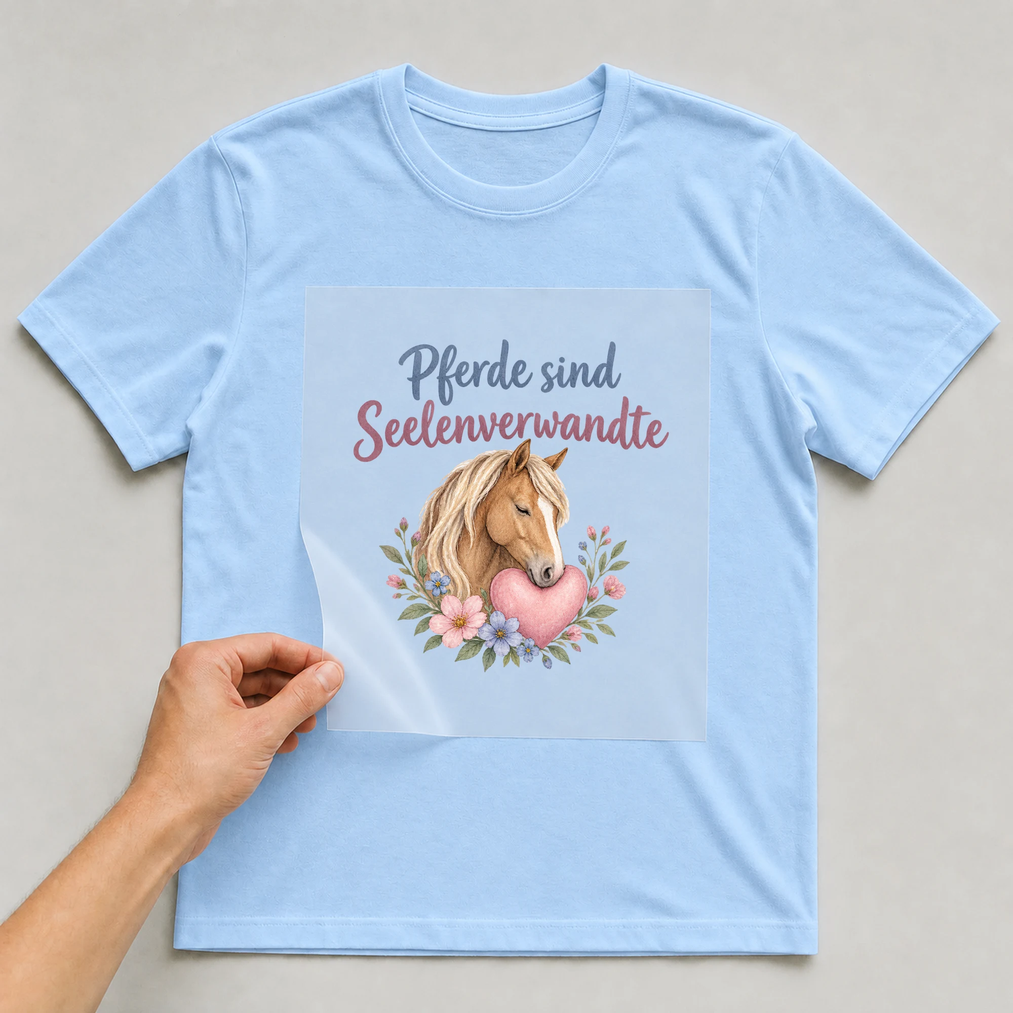 Bügelbild „Pferde sind Seelenverwandte“ auf babyblauem T-Shirt, Folie wird aufgelegt