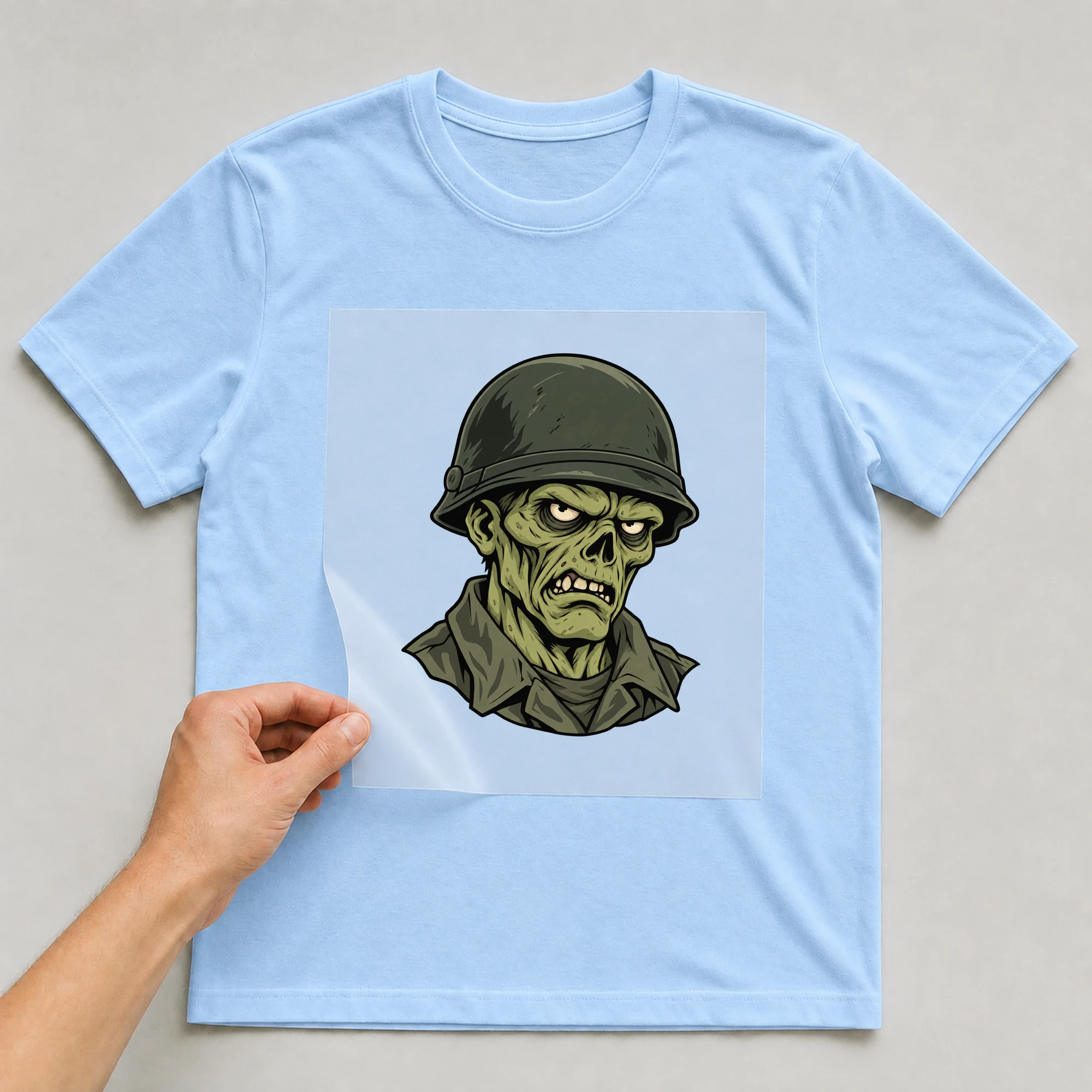 Bügelbild „Zombie Soldier“ auf babyblauem T-Shirt, Folie wird aufgelegt