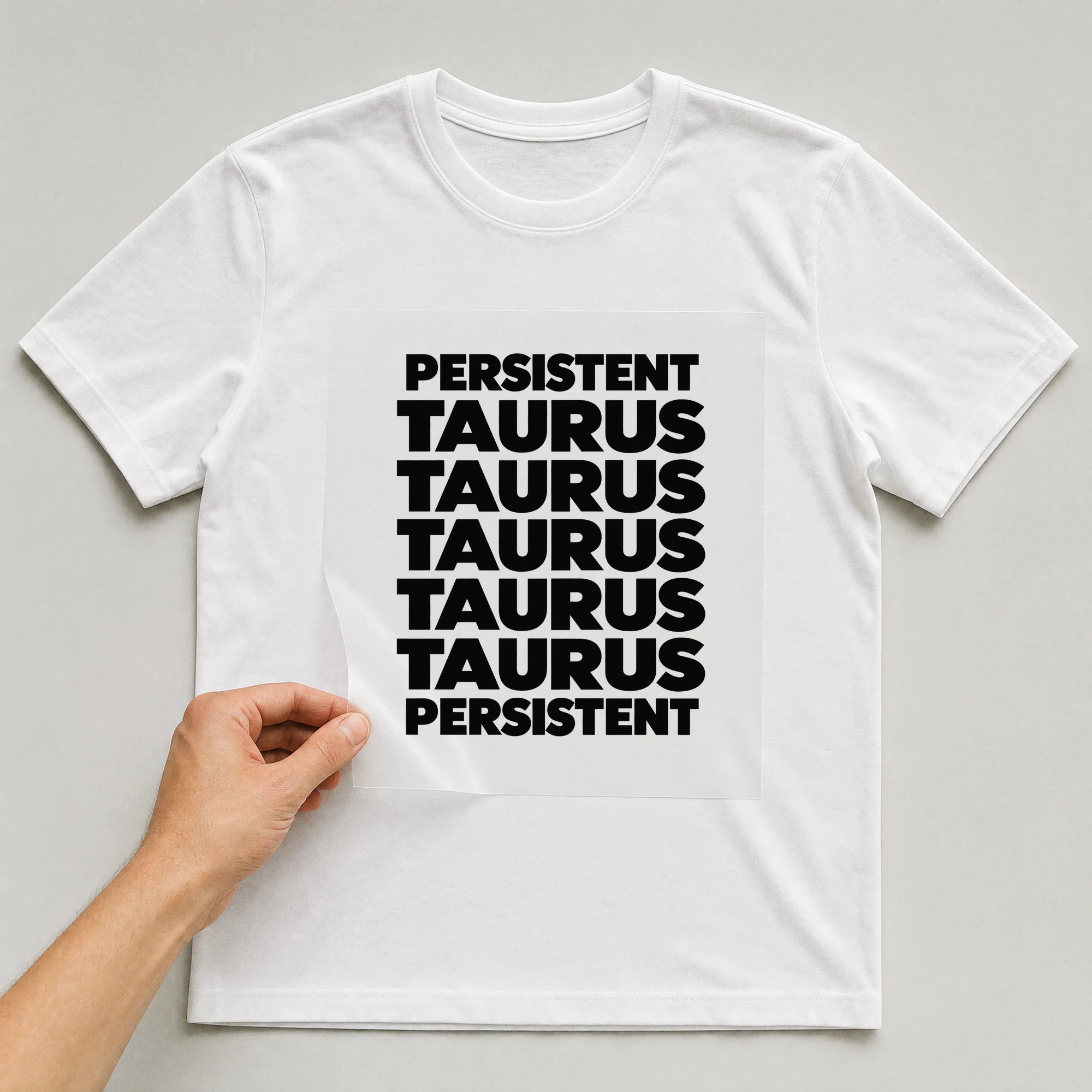 Bügelbild „Persistent Taurus Taurus Taurus Taurus Taurus Persistent“ auf weißem T-Shirt, Folie wird aufgelegt