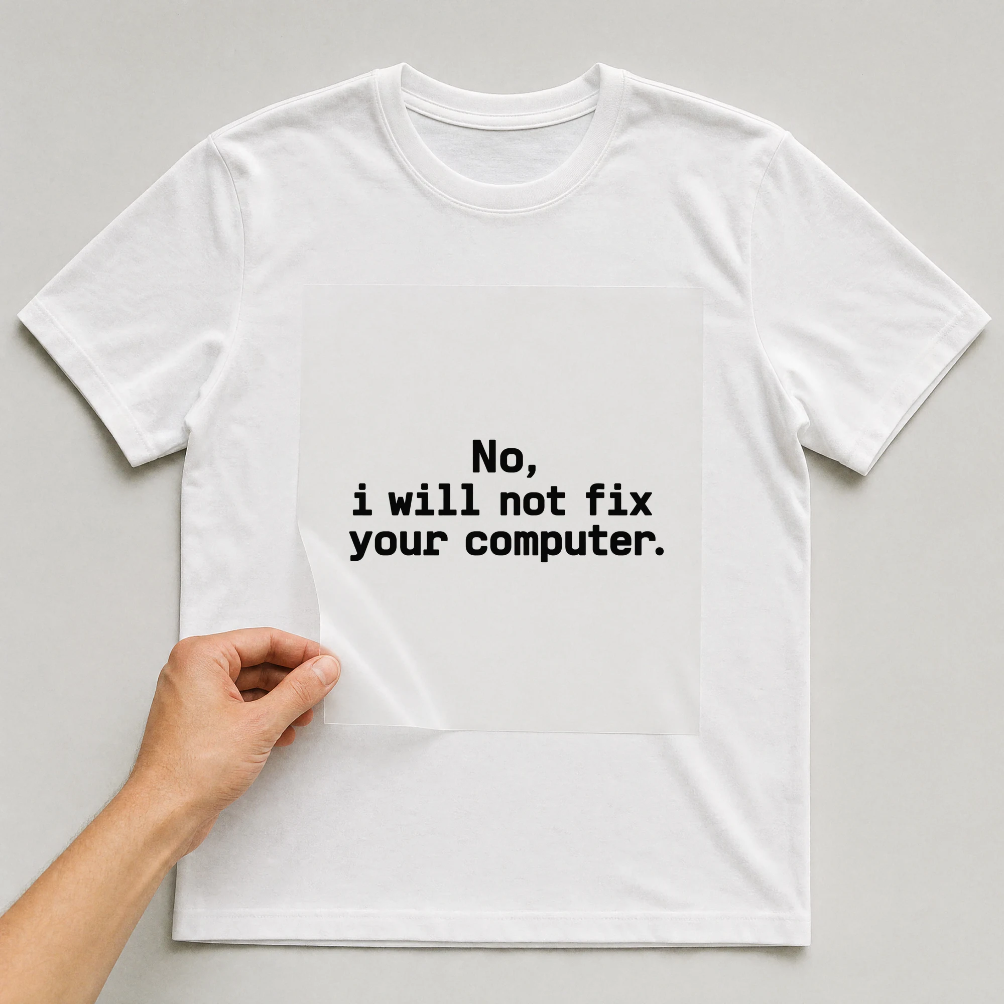 Bügelbild „No, i will not fix your computer.“ auf weißem T-Shirt, Folie wird aufgelegt