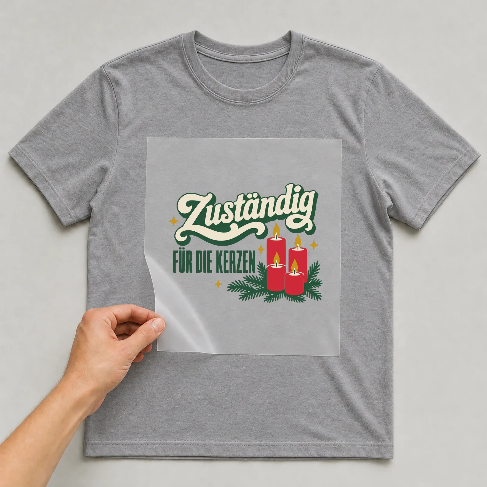 Bügelbild Zuständig für die Kerzen auf grauem T-Shirt, Folie wird aufgelegt