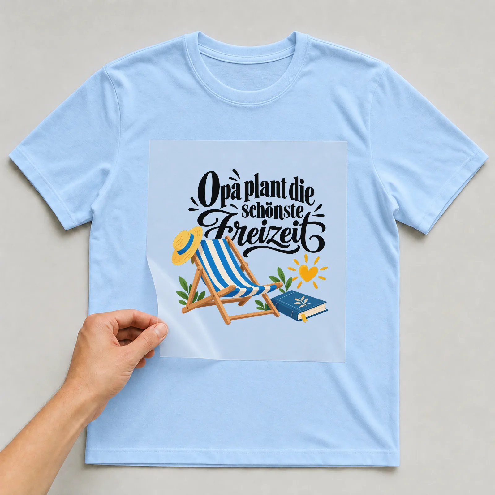 Bügelbild „Opa plant die schönste Freizeit“ auf hellblauem T-Shirt, Folie wird aufgelegt