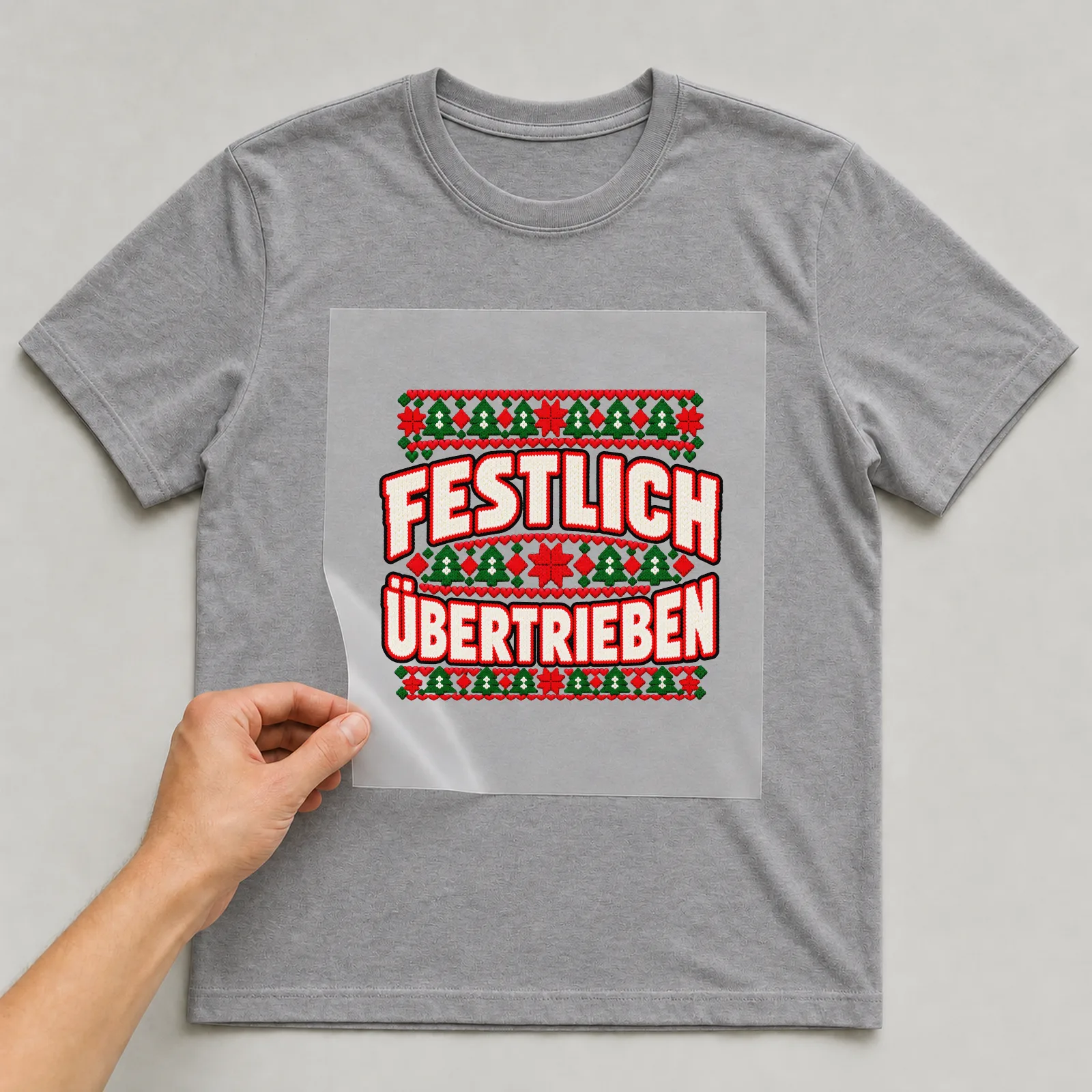 Bügelbild Festlich übertrieben auf grauem T-Shirt, Folie wird aufgelegt