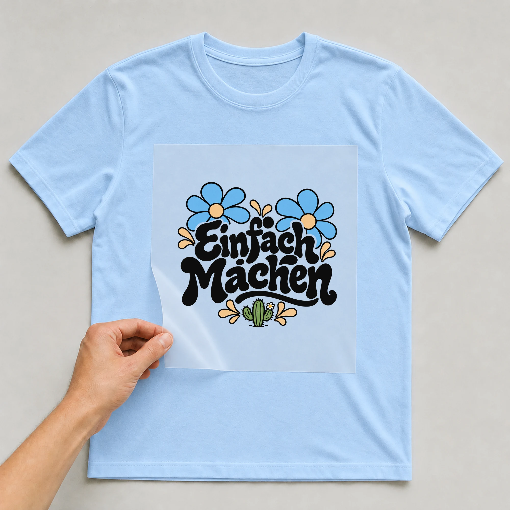Bügelbild „Einfach machen“ auf babyblauem T-Shirt, Folie wird aufgelegt
