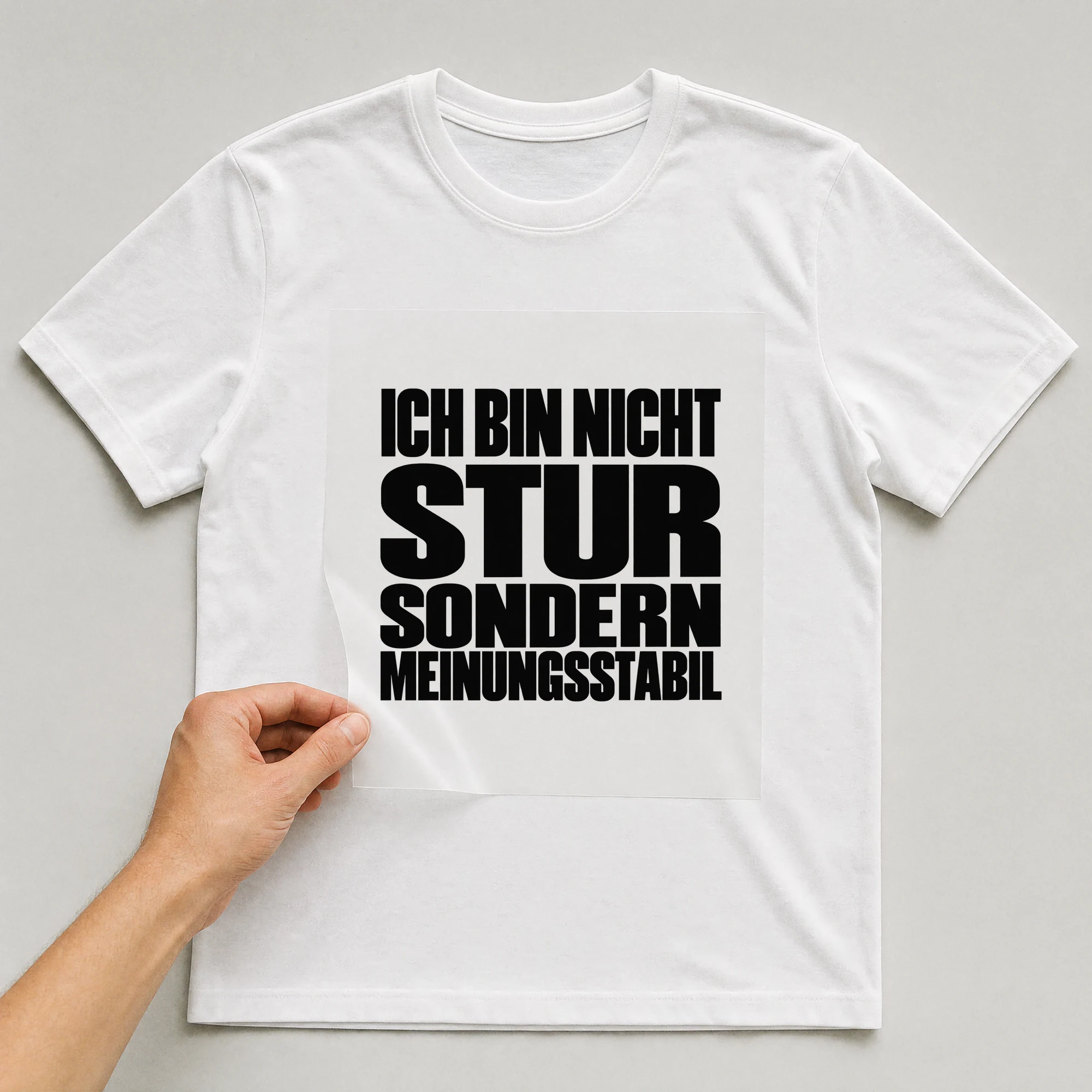 Bügelbild „Ich Bin Nicht Stur Sondern Meinungsstabil“ auf weißem T-Shirt, Folie wird aufgelegt