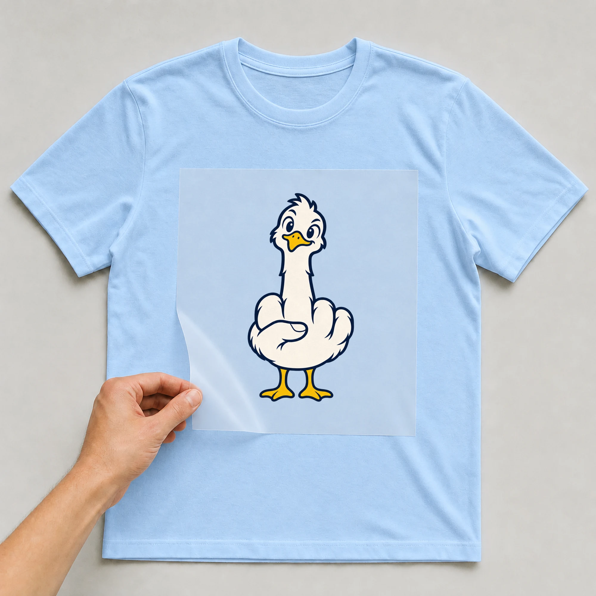Bügelbild „BB021157-motiv-r03697“ auf babyblauem T-Shirt, Folie wird aufgelegt