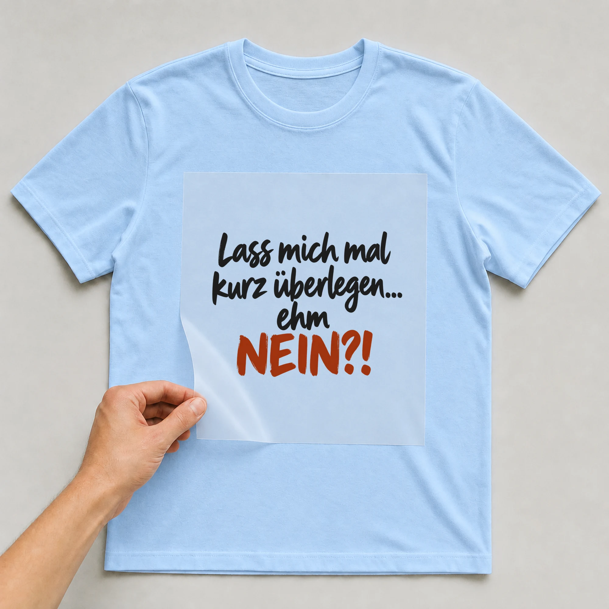 Bügelbild „Lass mich mal kurz überlegen... ehm NEIN?!“ auf babyblauem T-Shirt, Folie wird aufgelegt