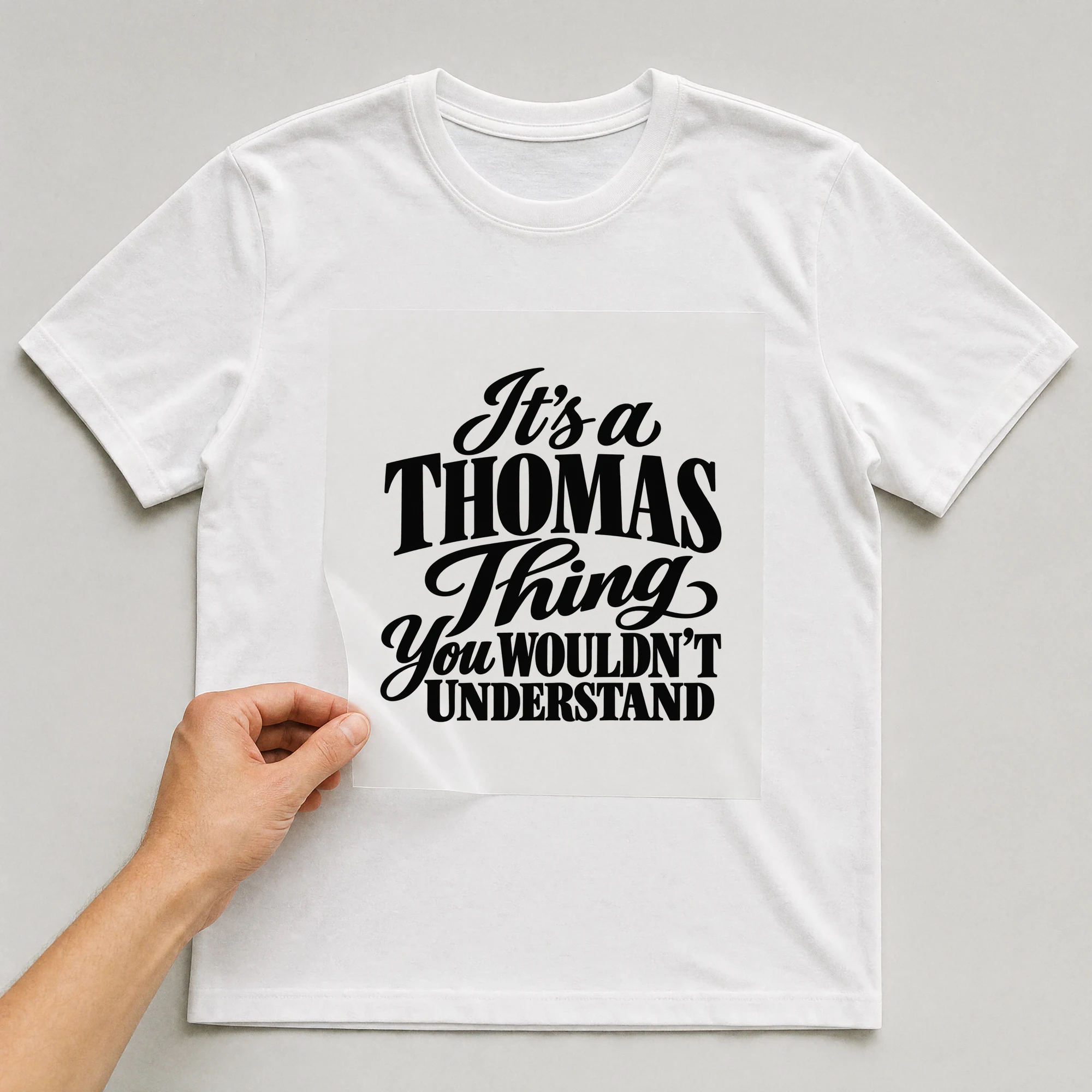Bügelbild „It's a THOMAS Thing You WOULDN'T UNDERSTAND“ auf weißem T-Shirt, Folie wird aufgelegt