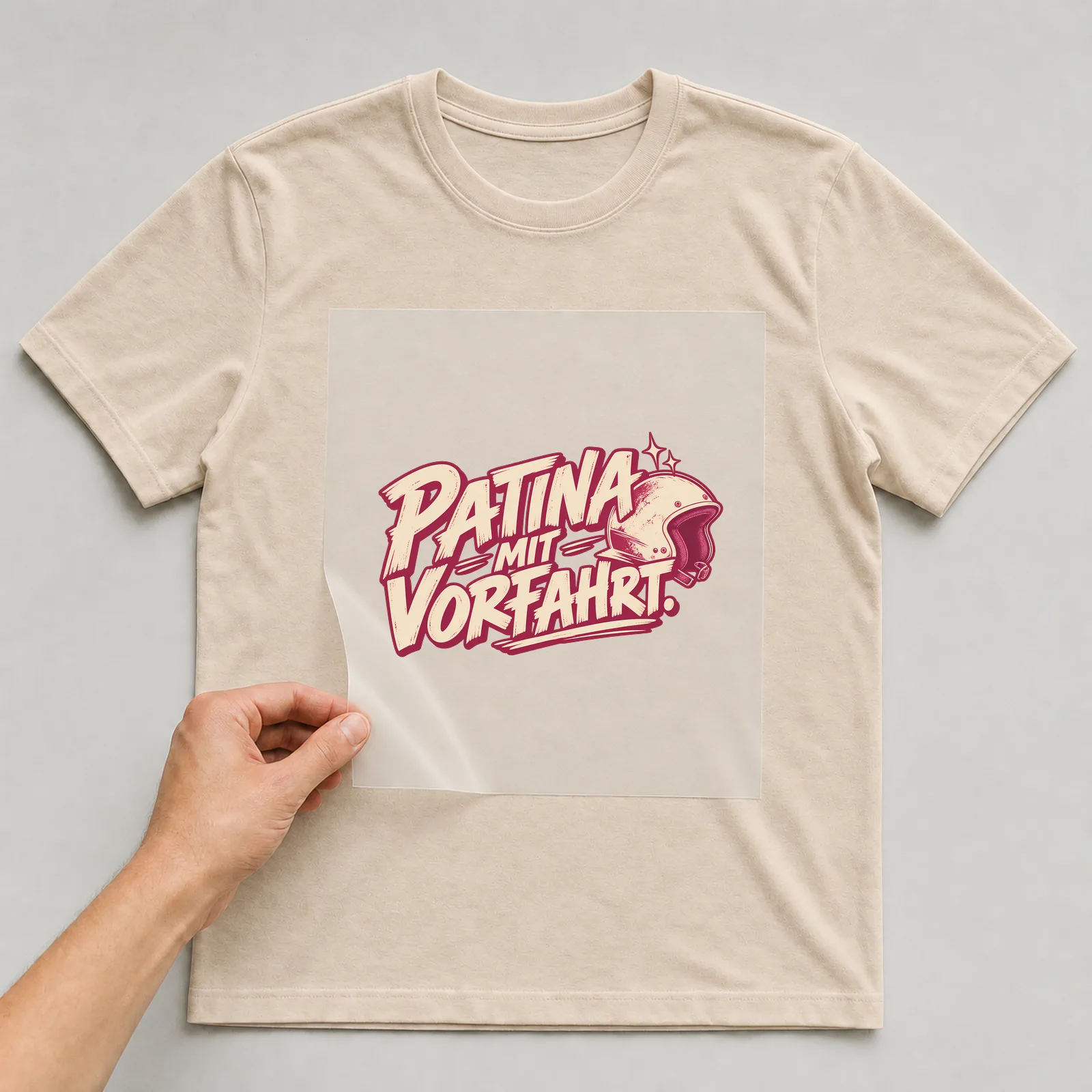 Bügelbild „Patina mit Vorfahrt“ auf beigem T-Shirt, Folie wird aufgelegt