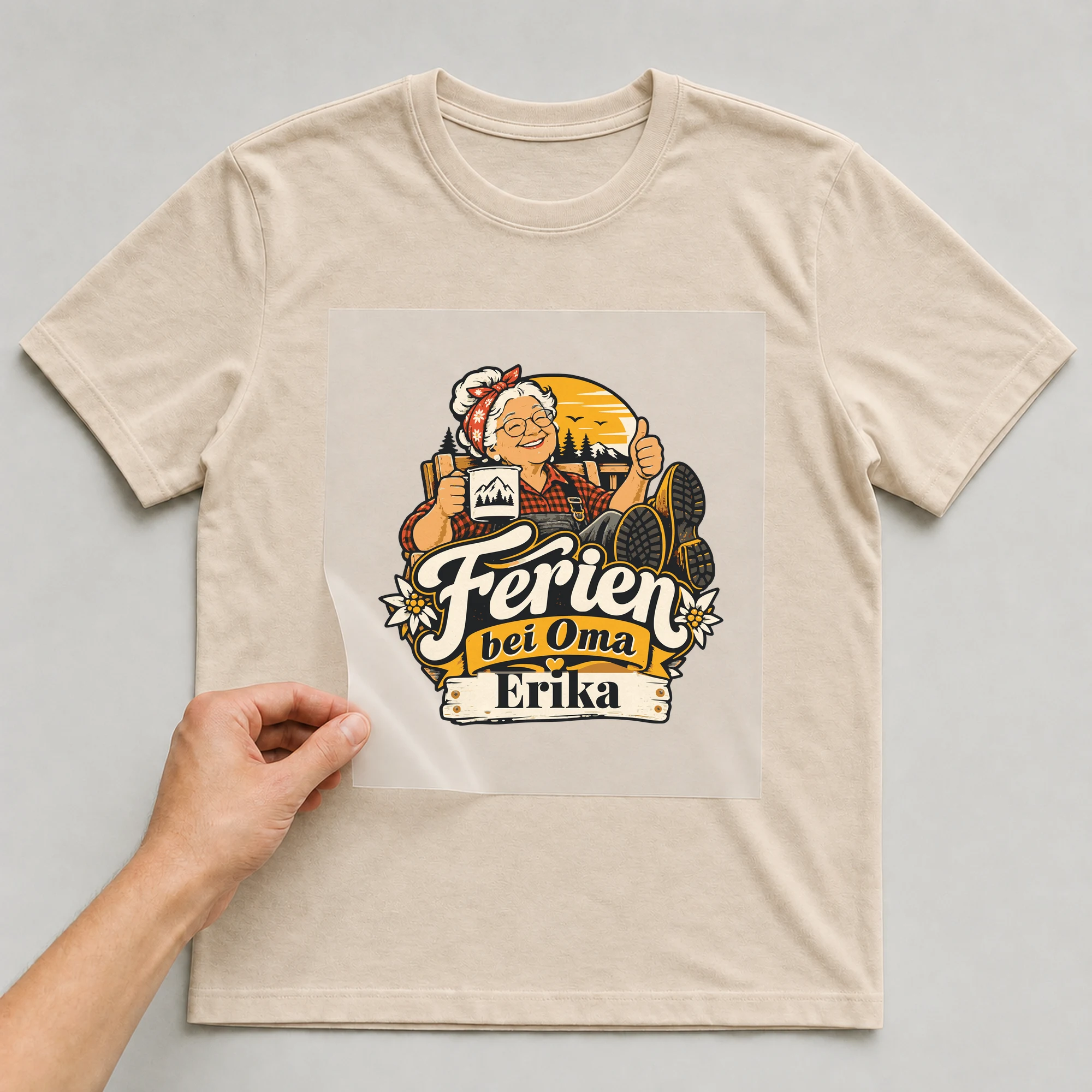 Bügelbild Ferien bei Oma mit Name auf beigem T-Shirt, Folie wird aufgelegt