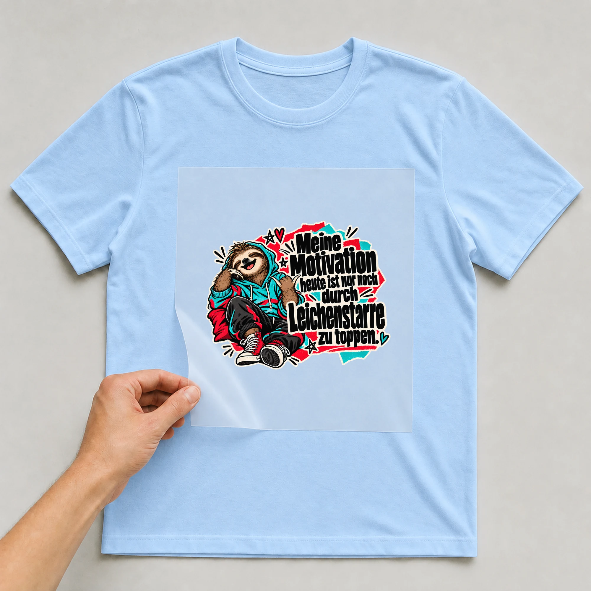 Bügelbild „Meine Motivation heute“ auf babyblauem T-Shirt, Folie wird aufgelegt