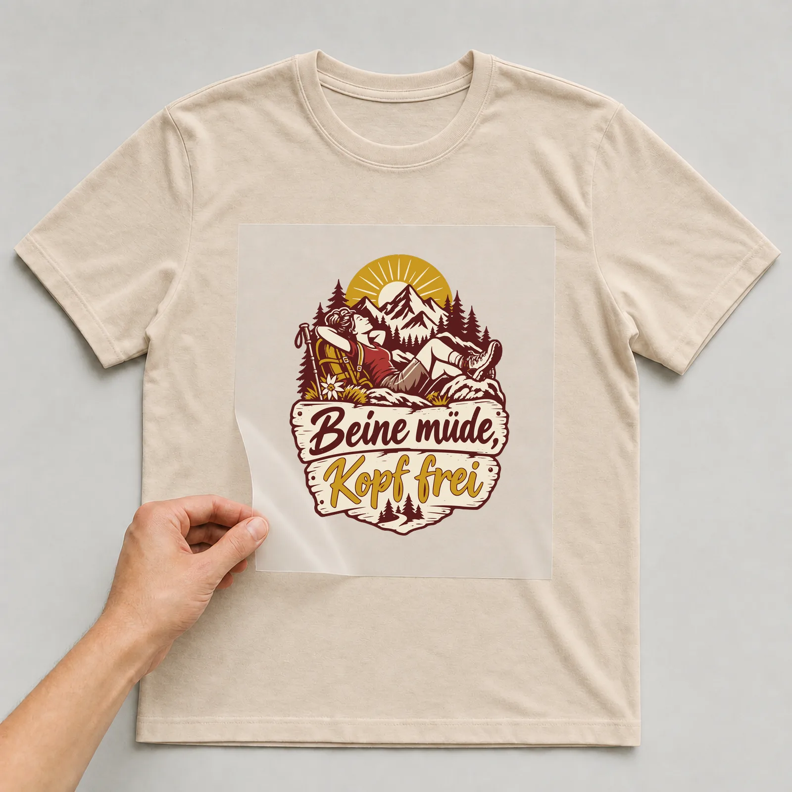 Bügelbild Beine müde, Kopf frei auf beigem T-Shirt, Folie wird aufgelegt