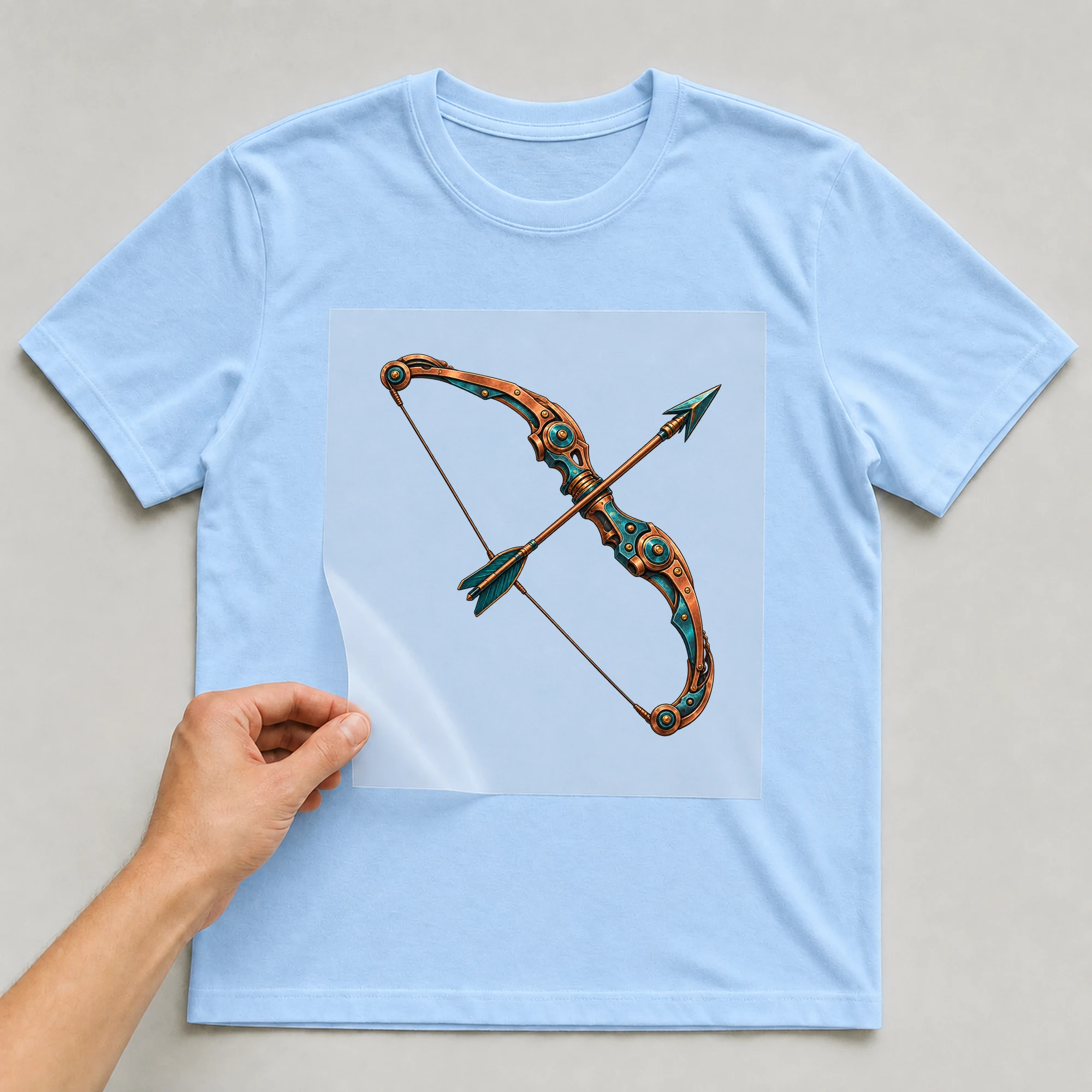 Bügelbild „Mecha Roboter Sternzeichen Schütze“ auf babyblauem T-Shirt, Folie wird aufgelegt
