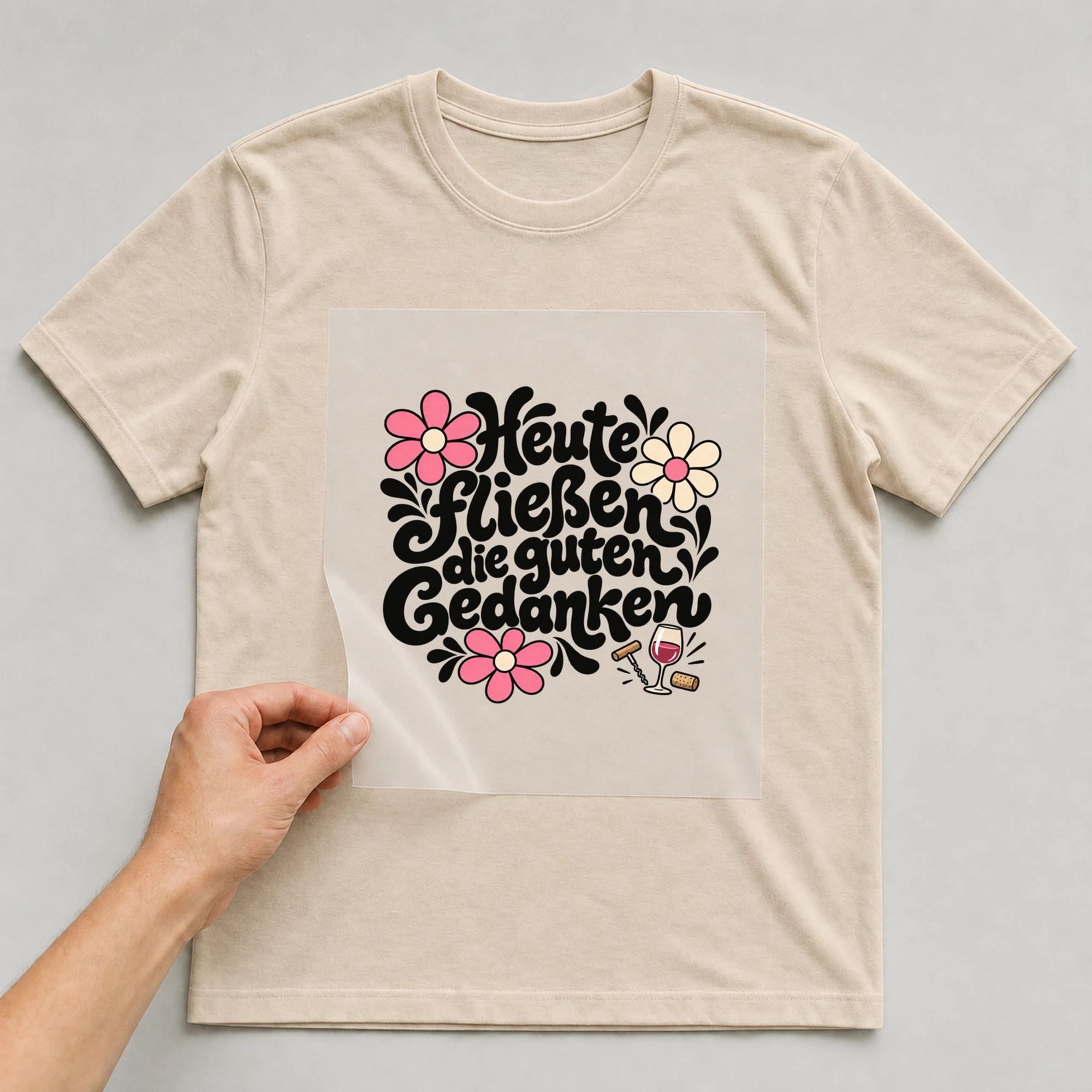 Bügelbild „Heute fließen die guten Gedanken“ auf beigem T-Shirt, Folie wird aufgelegt