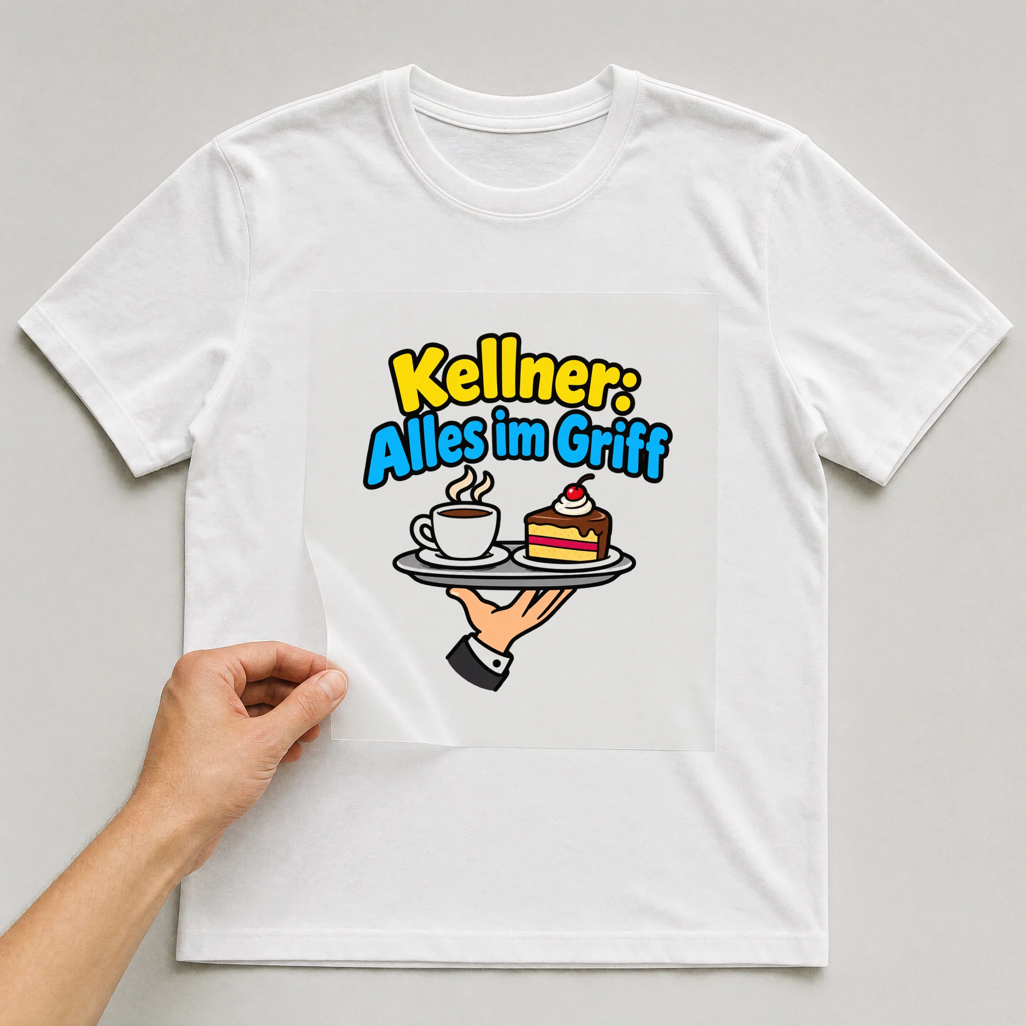 Bügelbild „Kellner: Alles im Griff“ auf weißem T-Shirt, Folie wird aufgelegt